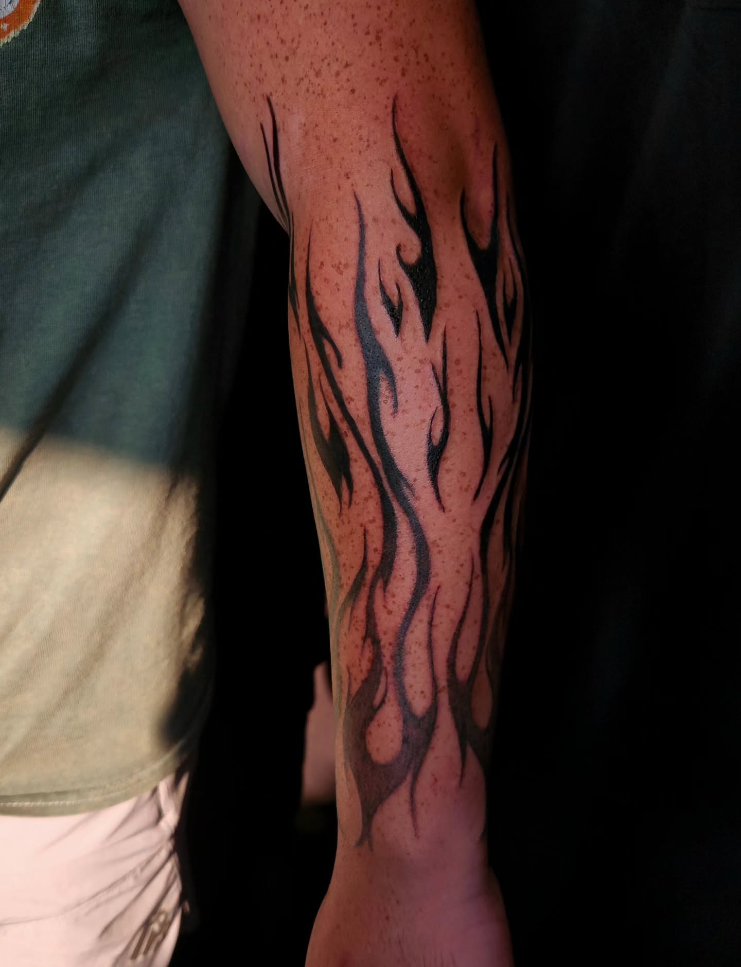 Flames tribal tattoo on the forearm by Ashly Renee