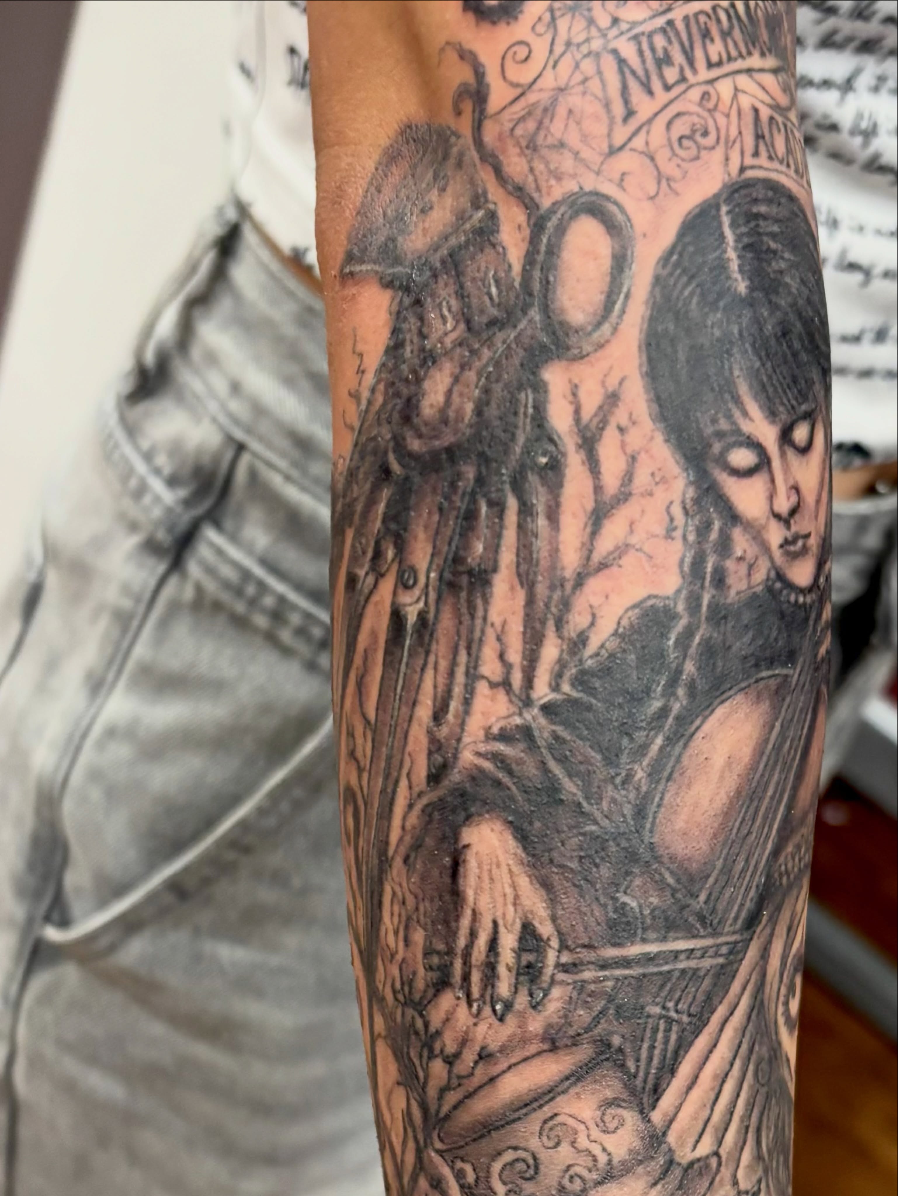 Angel and woman realism tattoo on the forearm by Thom Johns-Green