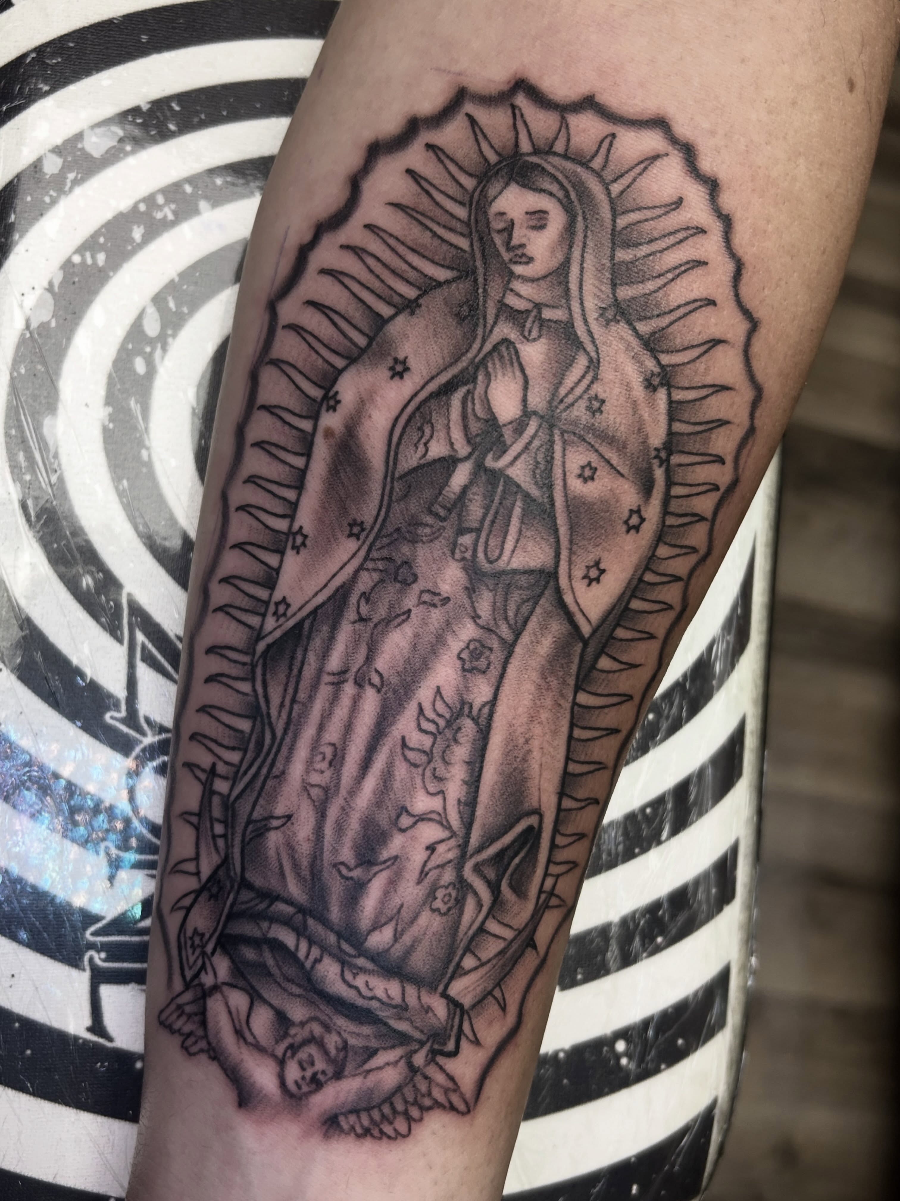 Our Lady of Guadalupe black and grey tattoo on the forearm by Dan Schuster