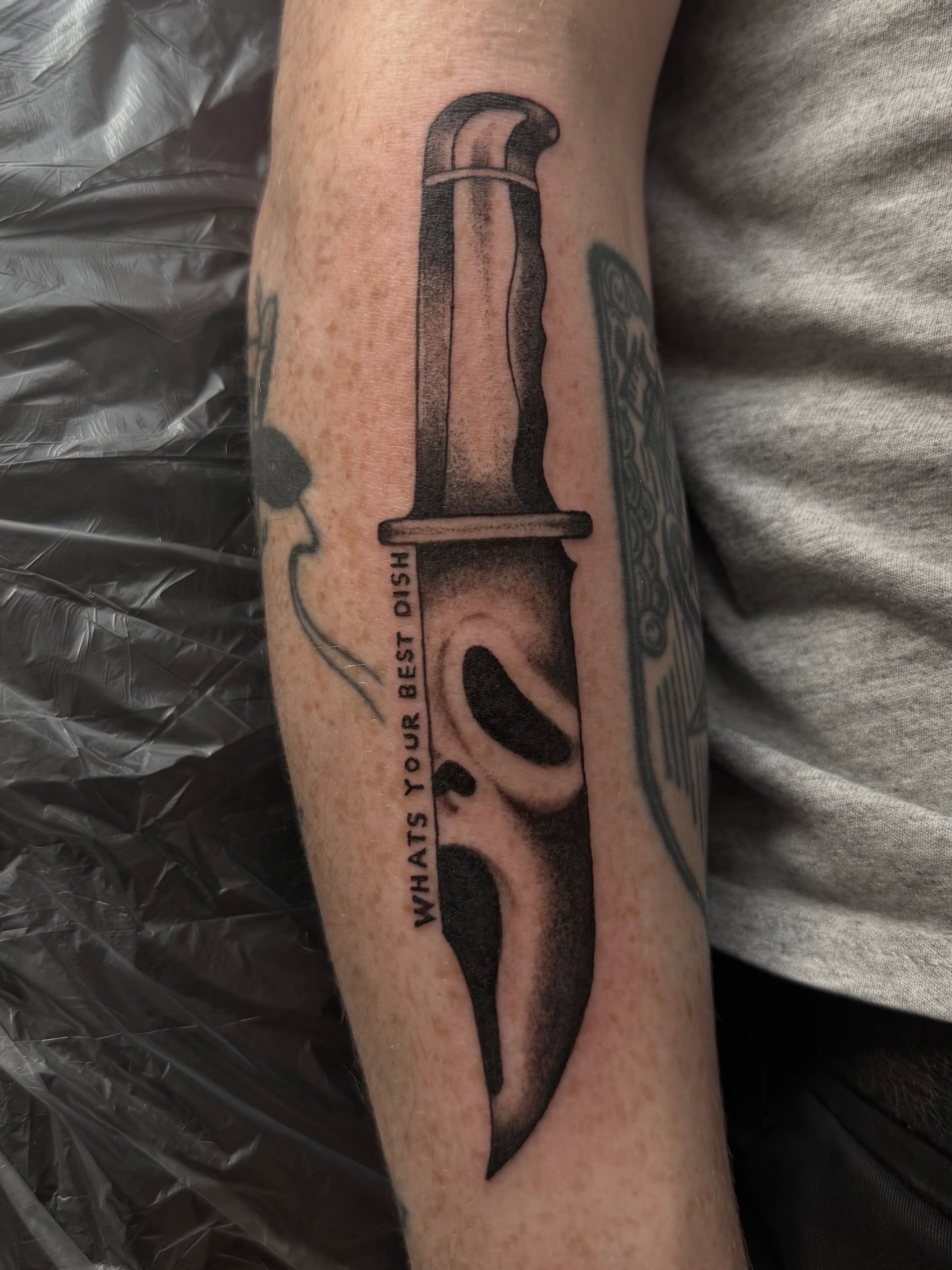 Knife black and grey tattoo on the forearm by Casper Tattoos Toronto