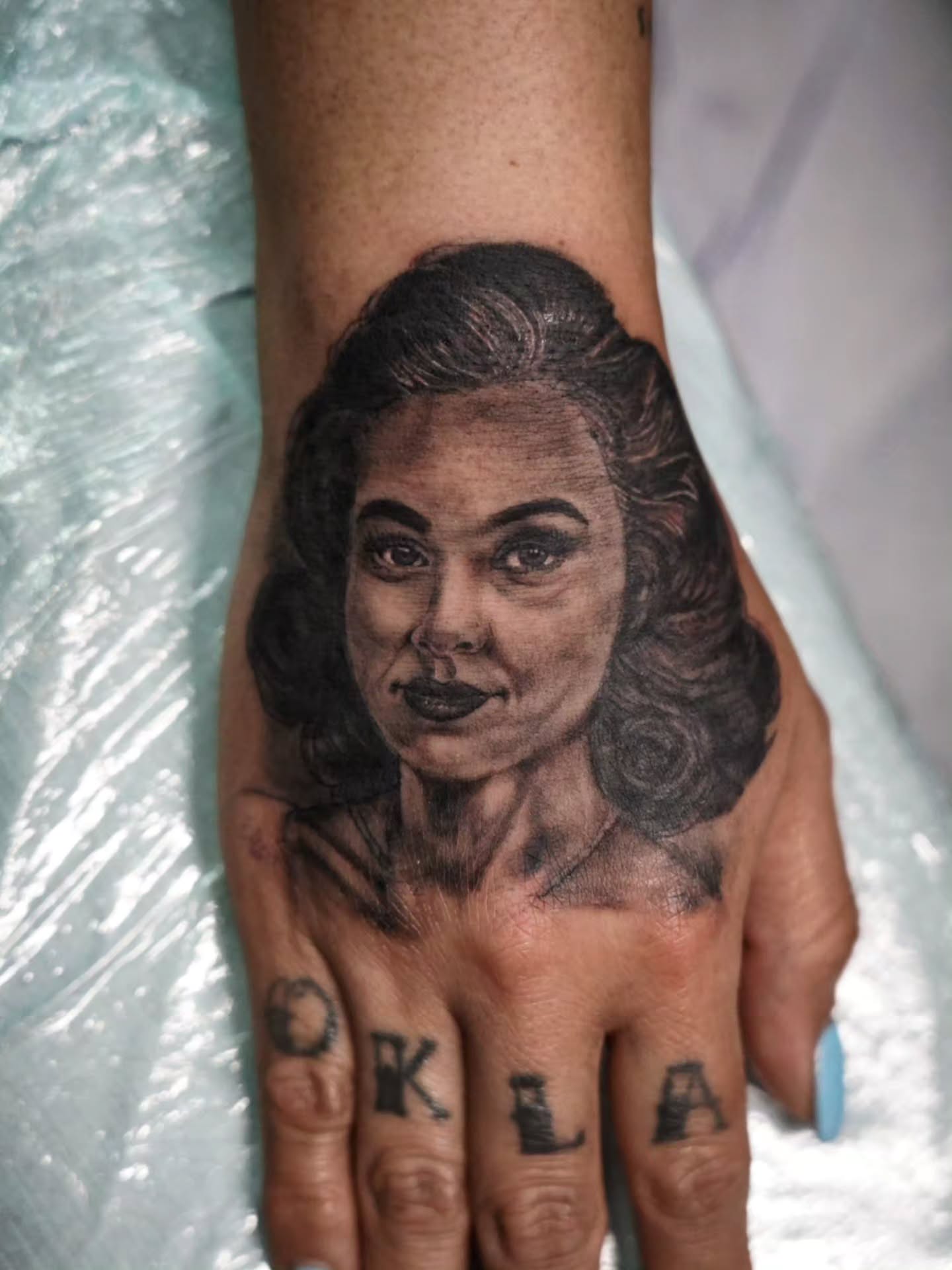 Portrait realism tattoo on the hand by Spicoli