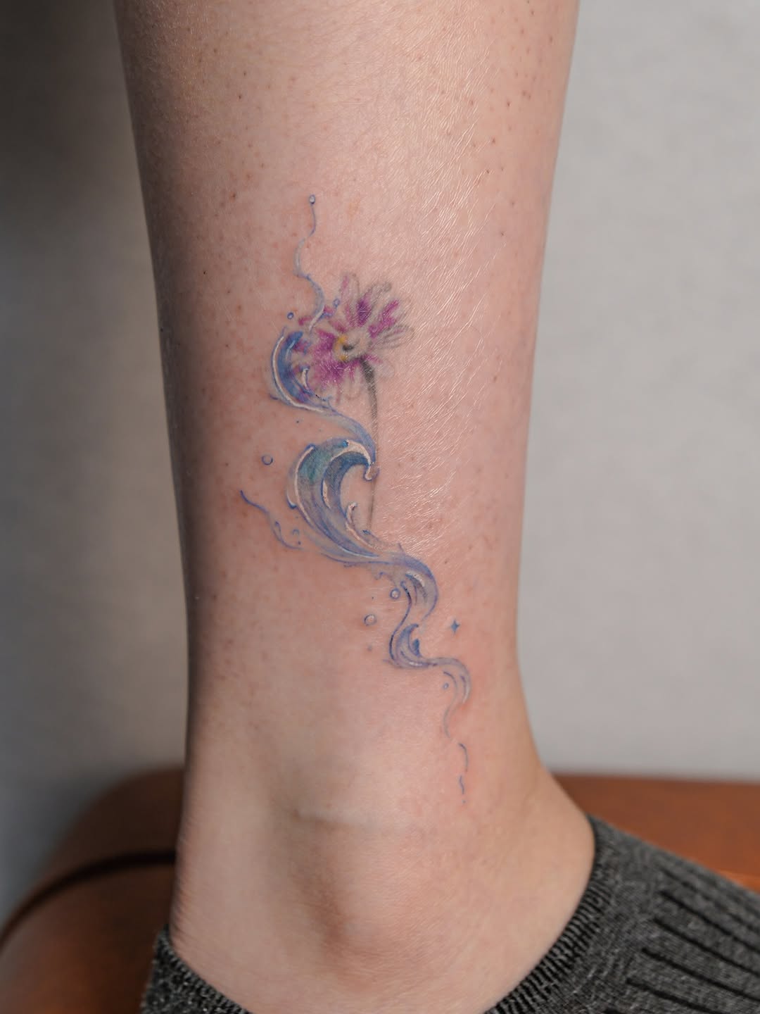 Flower and water watercolor tattoo on the forearm by Jinz