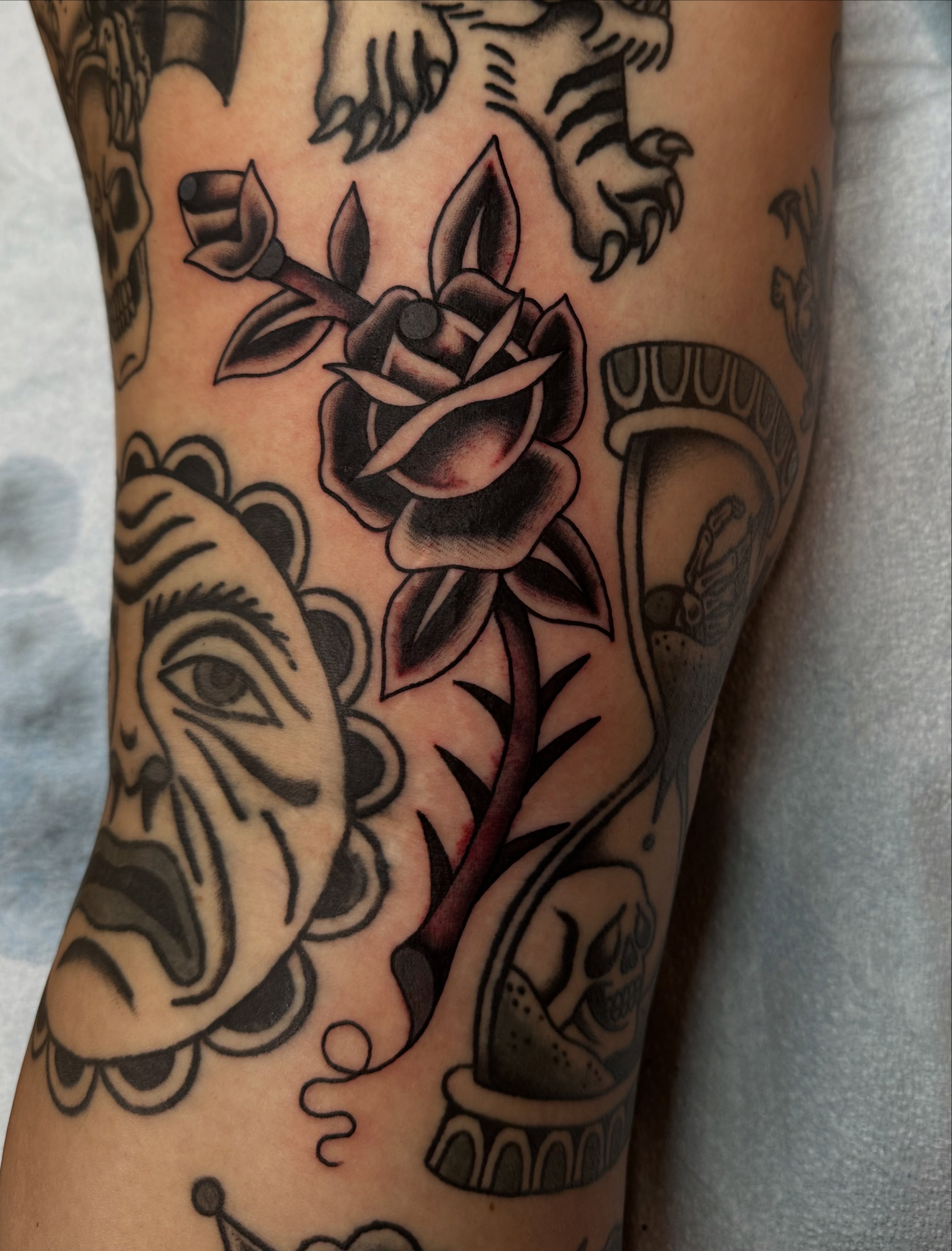 Rose and skull American traditional tattoo on the forearm by Emily Masa