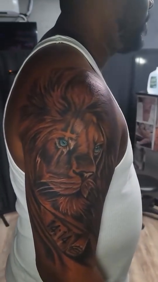 Lion portrait with roman numerals realism tattoo on the upper arm by Jose Onasis Disla, New York, New York