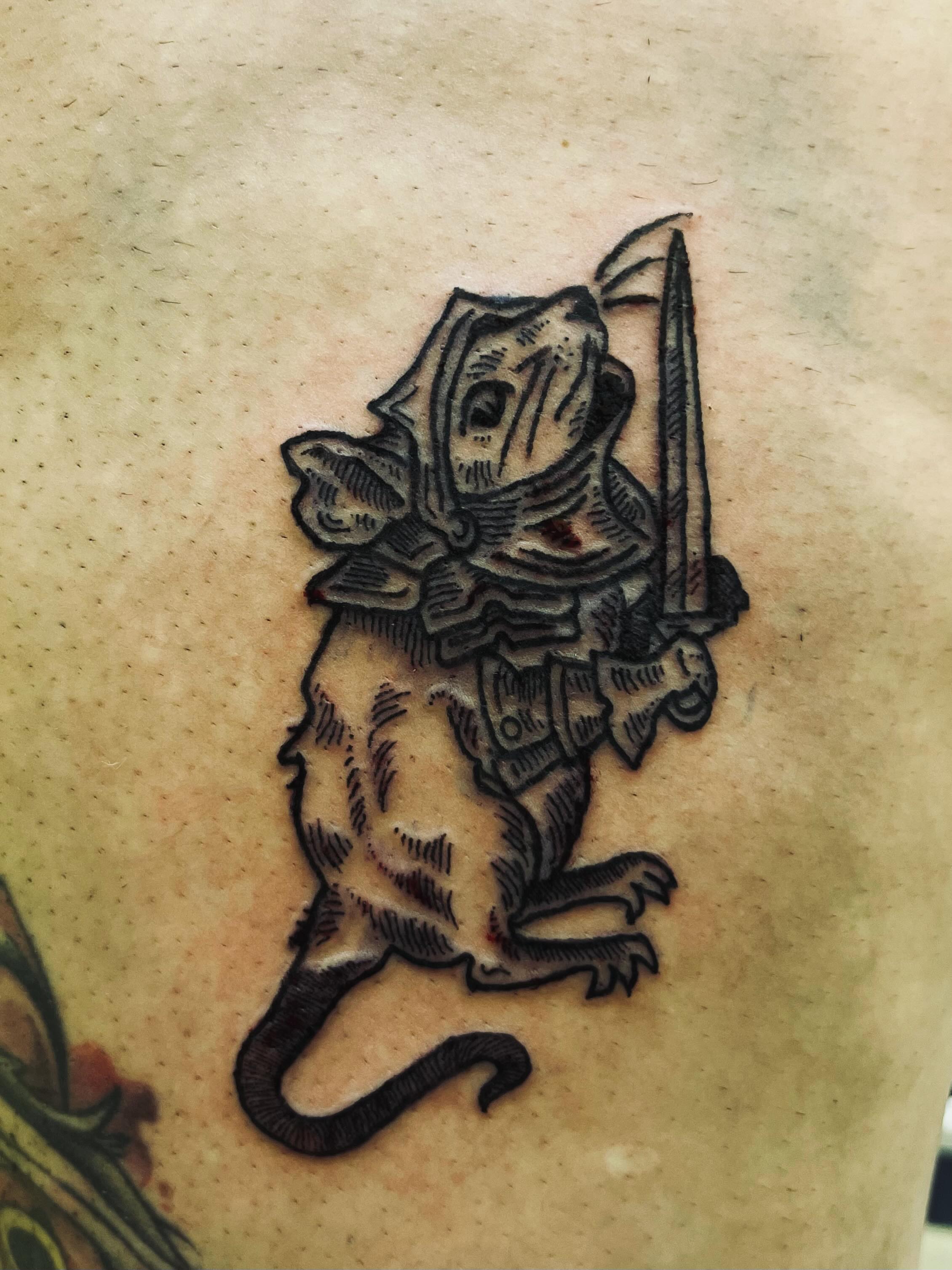 Cat knight black and grey tattoo on the thigh by Rafaela Lopez