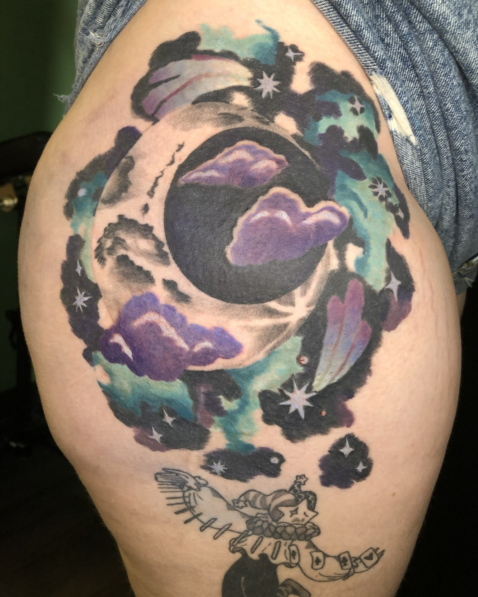 Moon and clouds watercolor tattoo on the shoulder by Rowan Lee