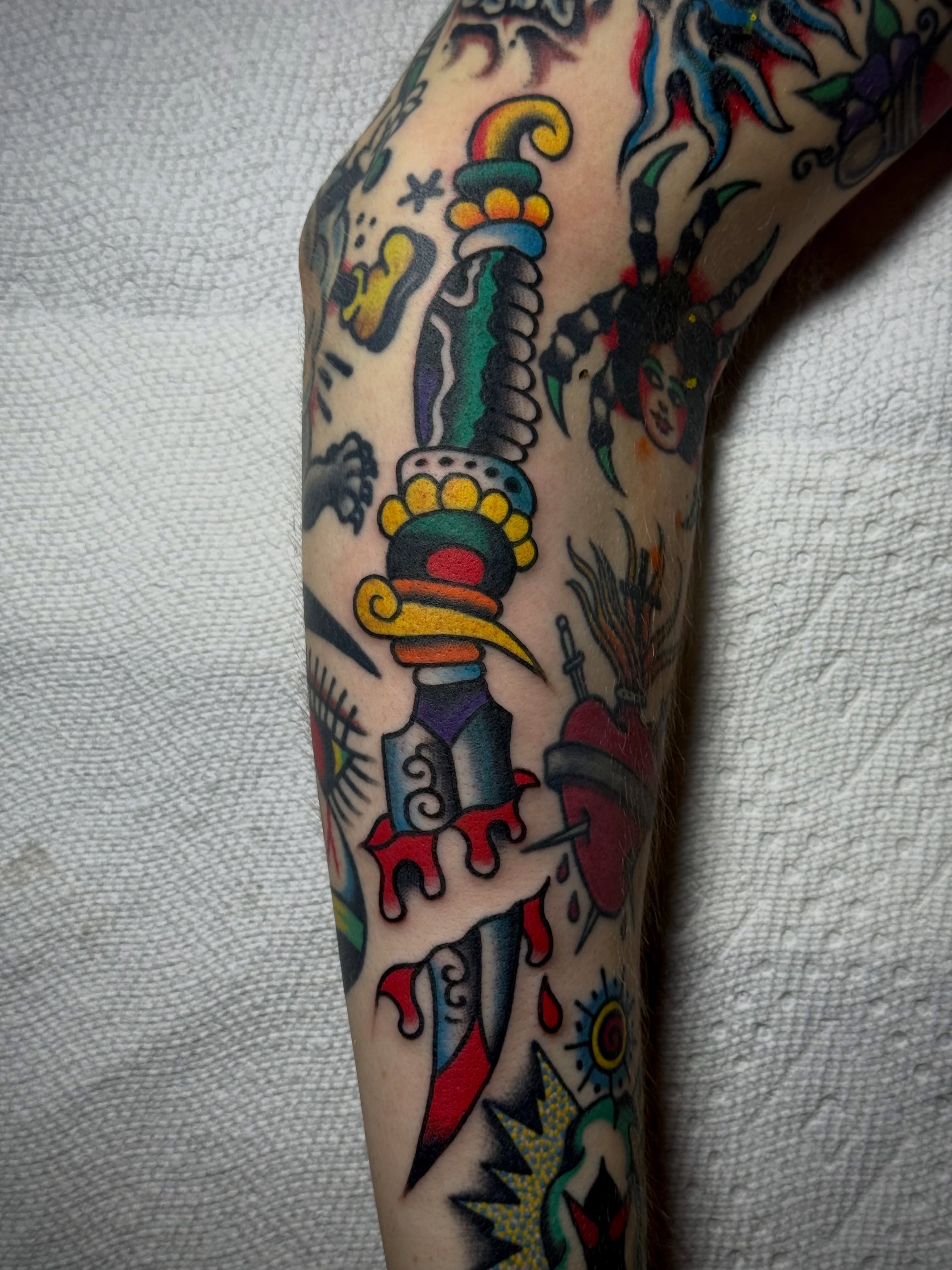 Knife with ornate handle American traditional tattoo on the forearm by Chuck Derek Whitaker