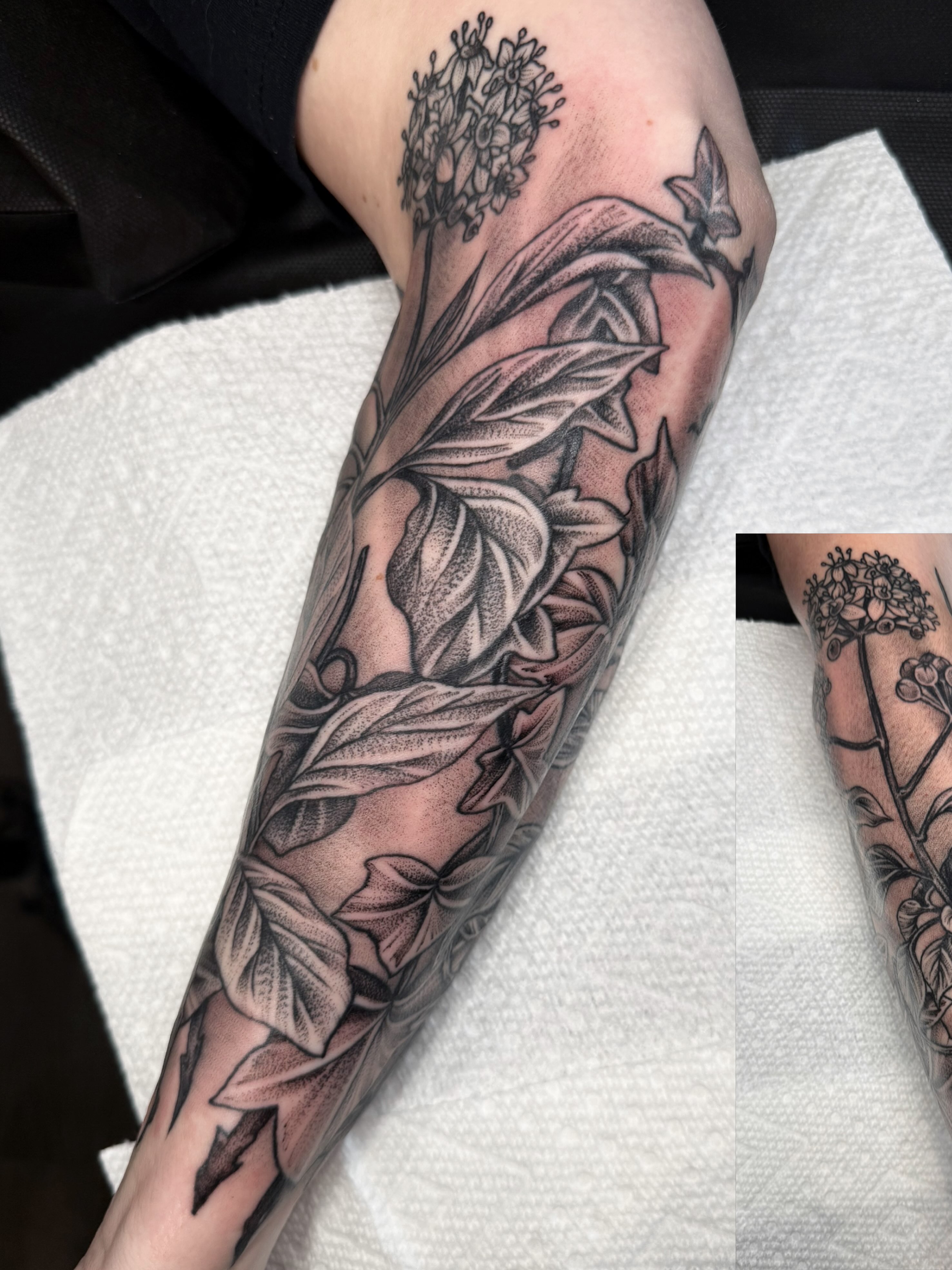 Flower and leaves black and grey tattoo on the forearm by Dani Johnson