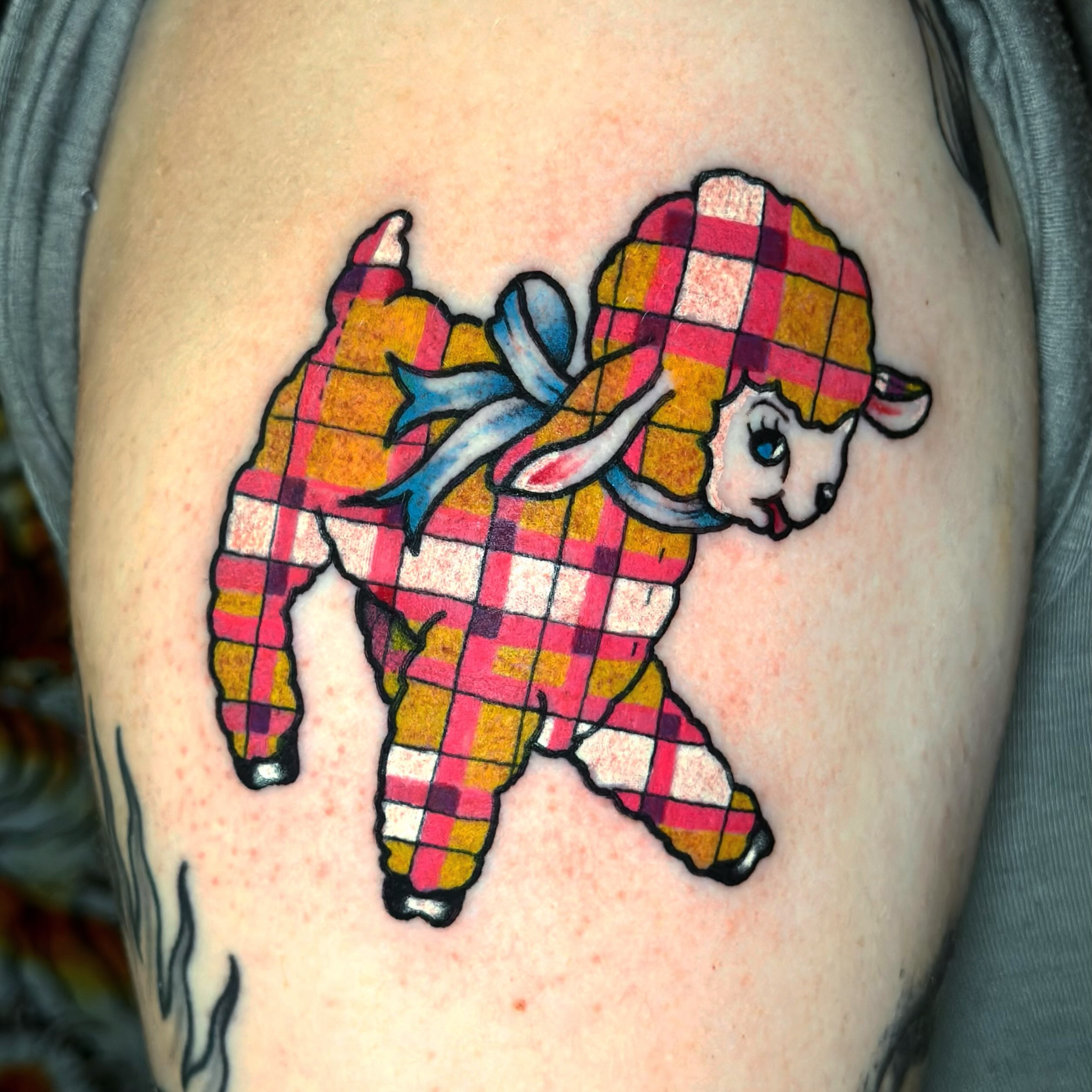 Plaid sheep new school tattoo on the thigh by Olive Kelley