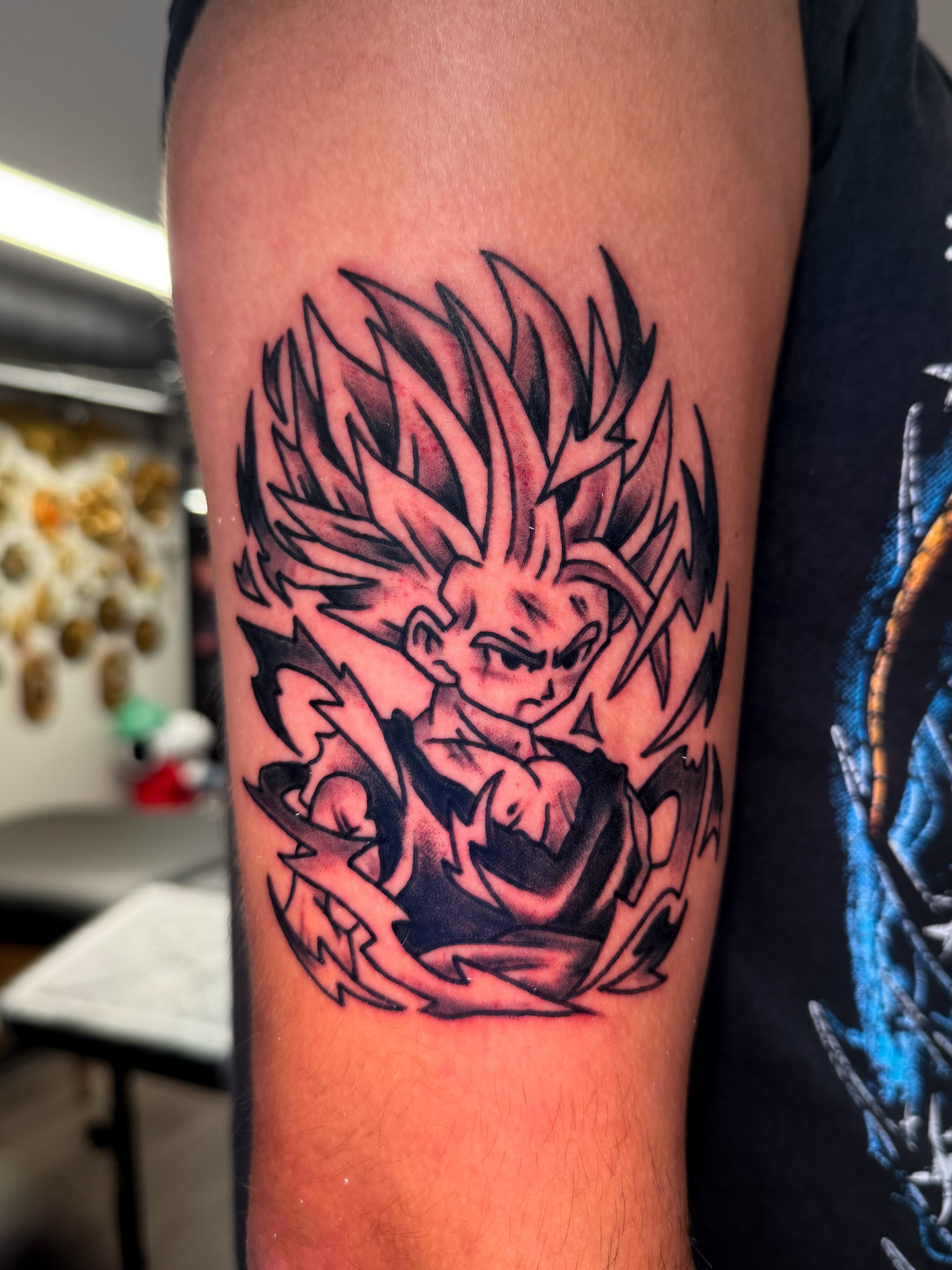Super saiyan anime tattoo on the forearm by Louie Flores