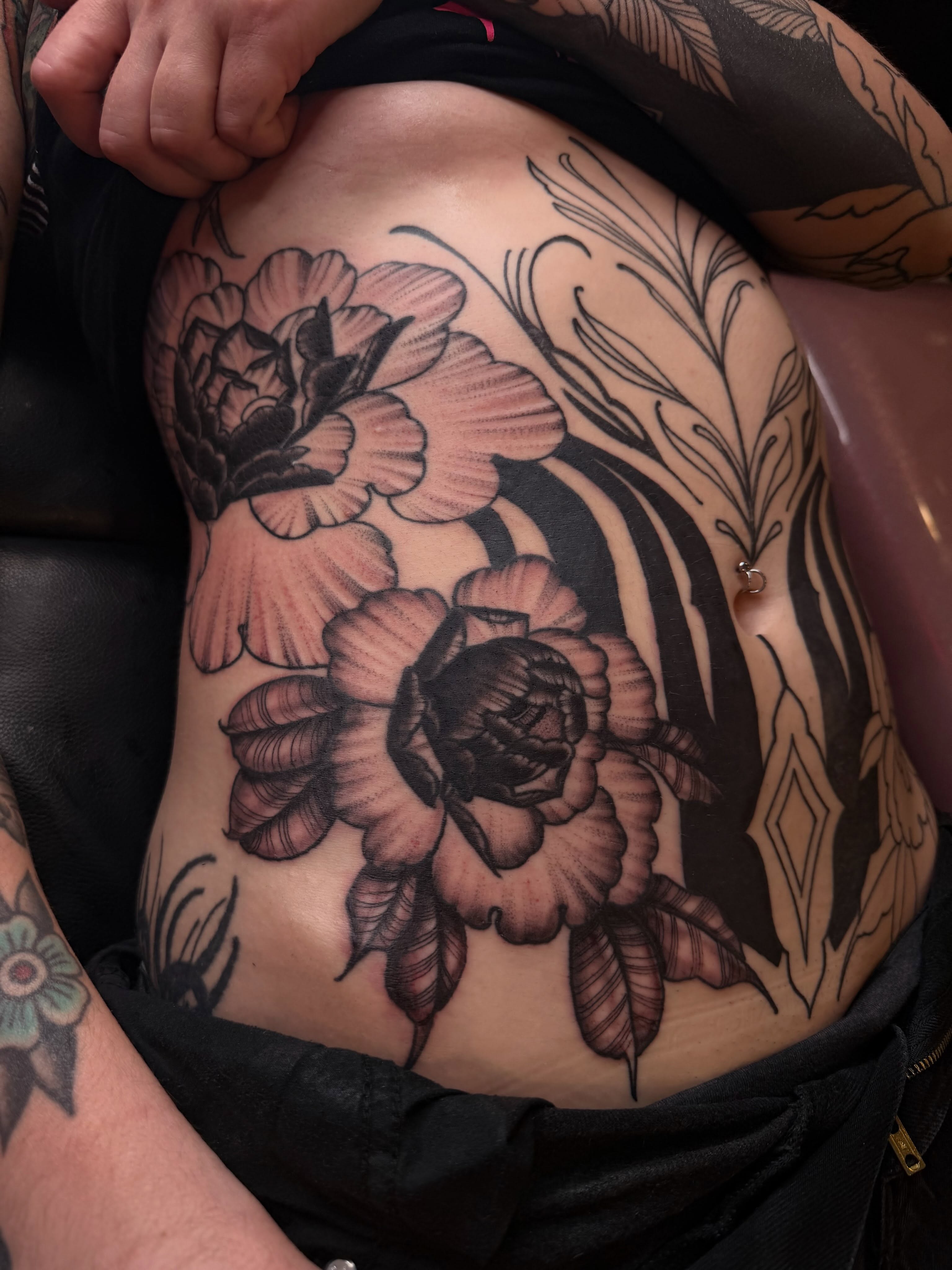 Peony flowers black and grey tattoo on the ribs by Mika Clairissa