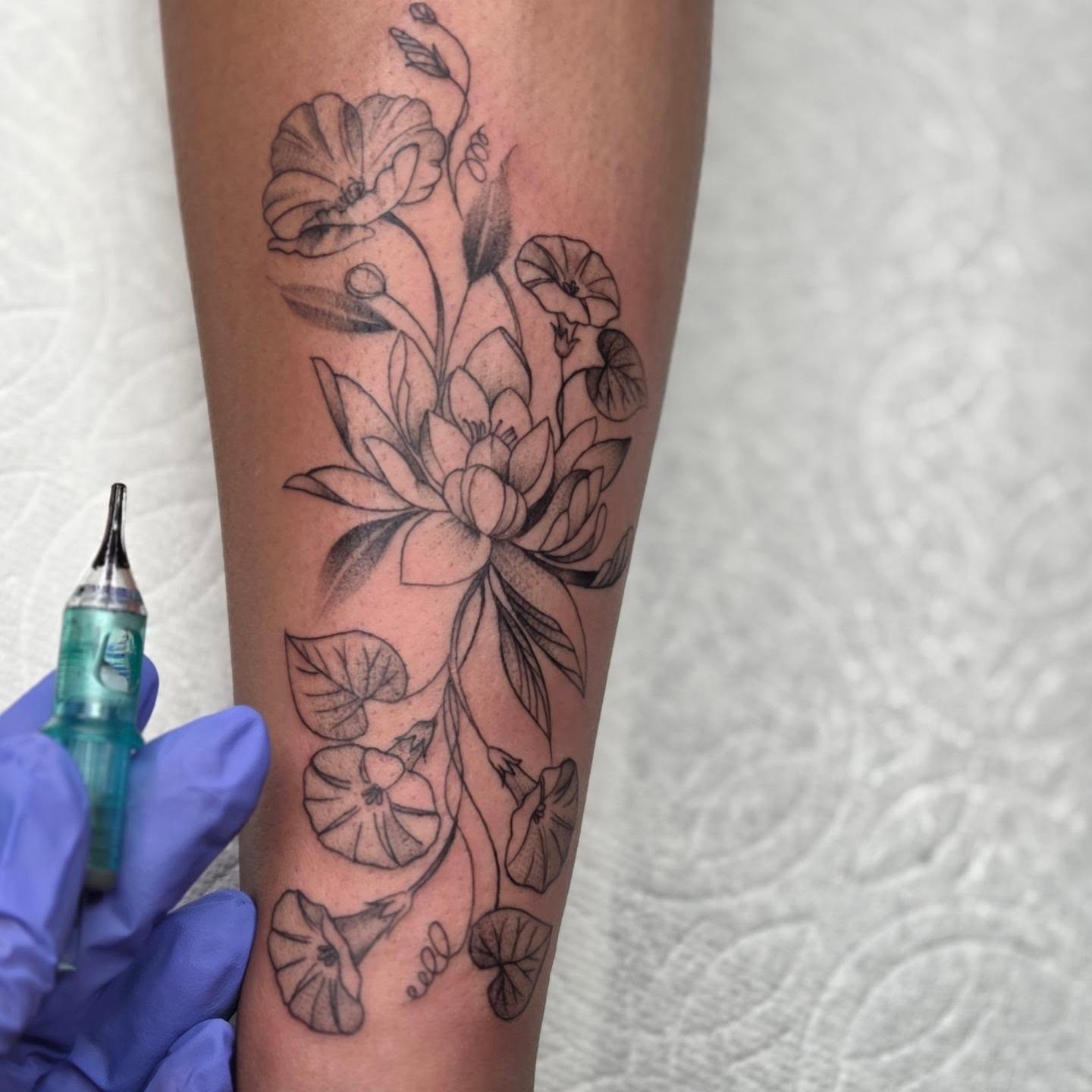 Lotus flowers black and grey tattoo on the forearm by Yvette Cebreros