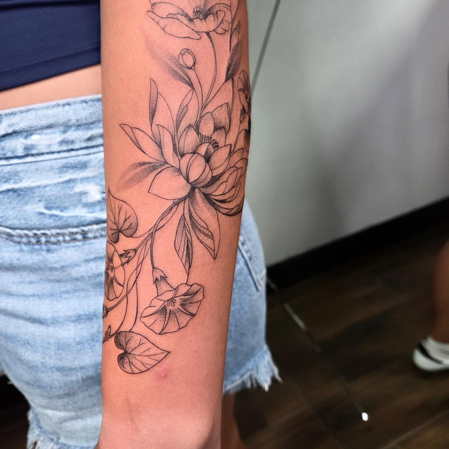 Lotus flowers black and grey tattoo on the forearm by Yvette Cebreros