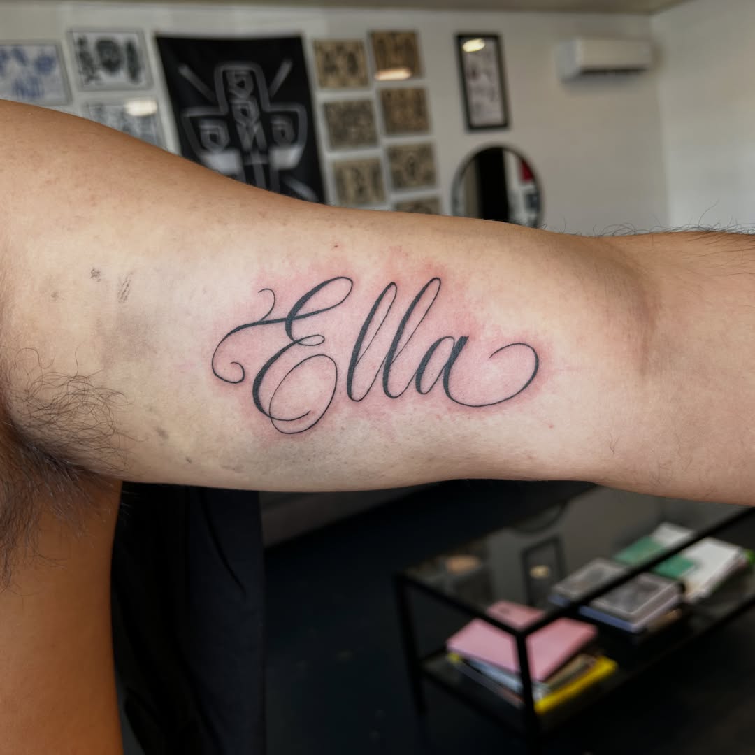 Ella lettering script tattoo on the forearm by Phoebe