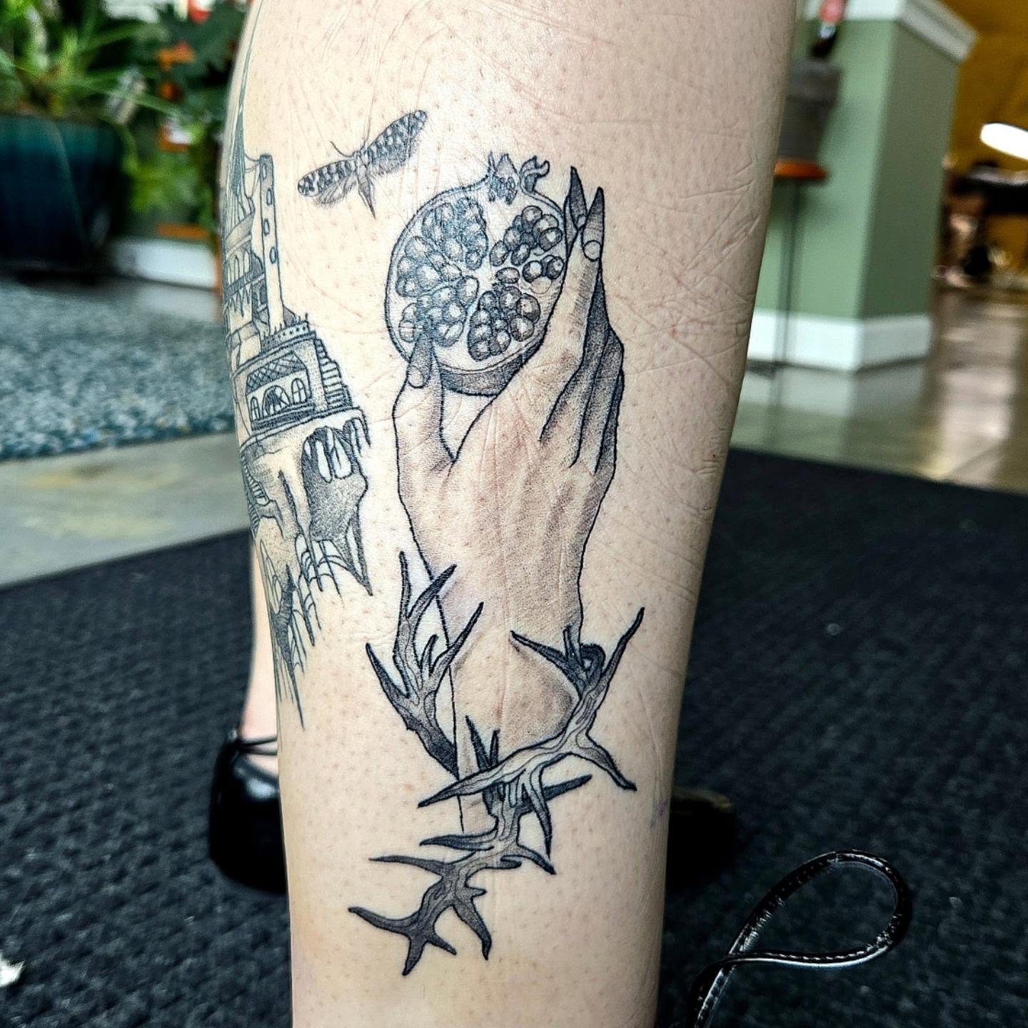 Pomegranate and hands realism tattoo on the forearm by Amanda Hinrichs