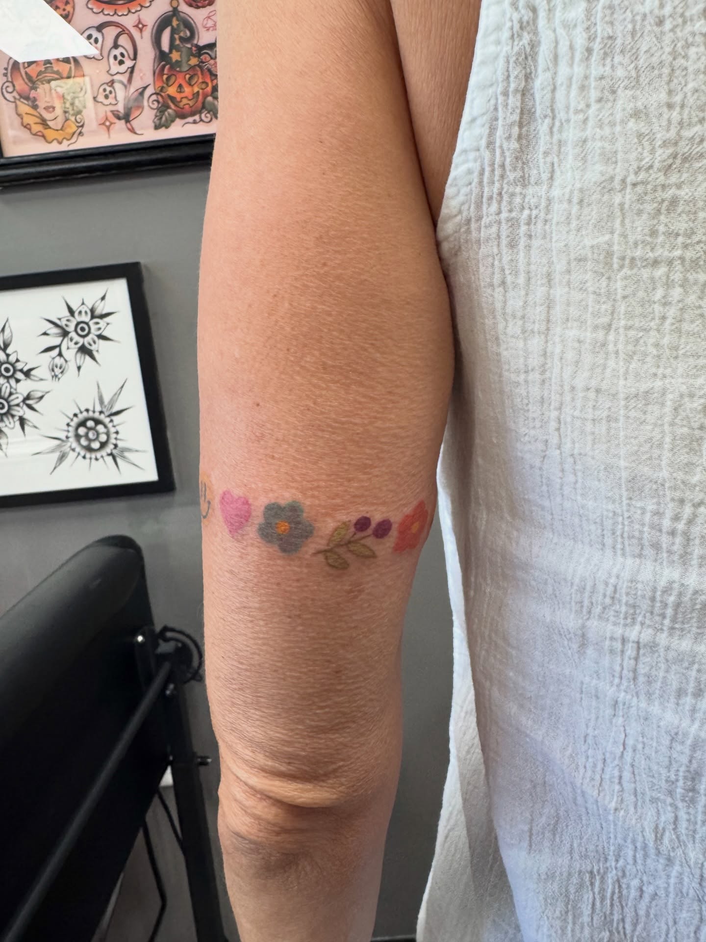 Flower and leaves new school tattoo on the forearm by Samantha Jane