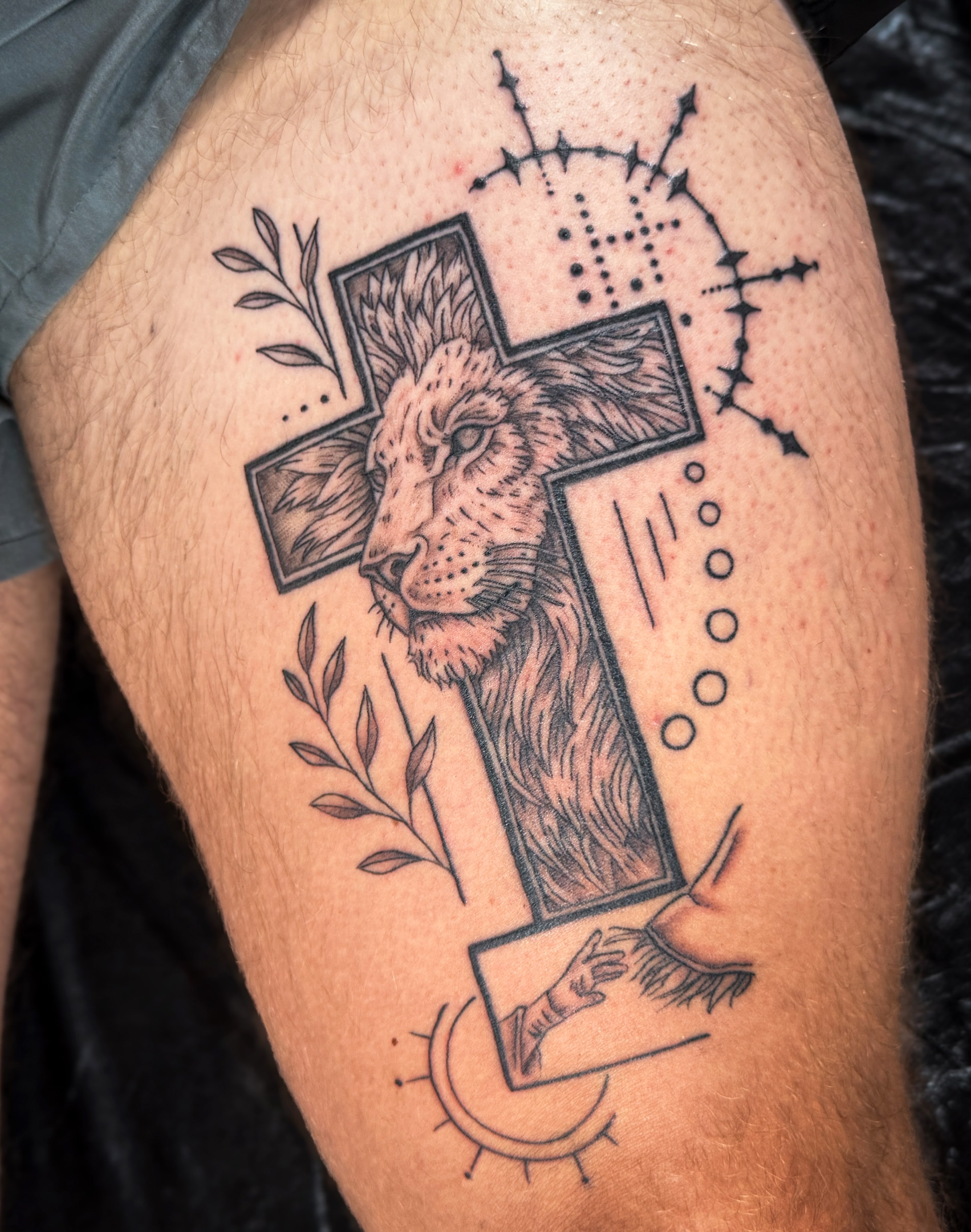 Lion and cross dotwork tattoo on the thigh by Ash✨