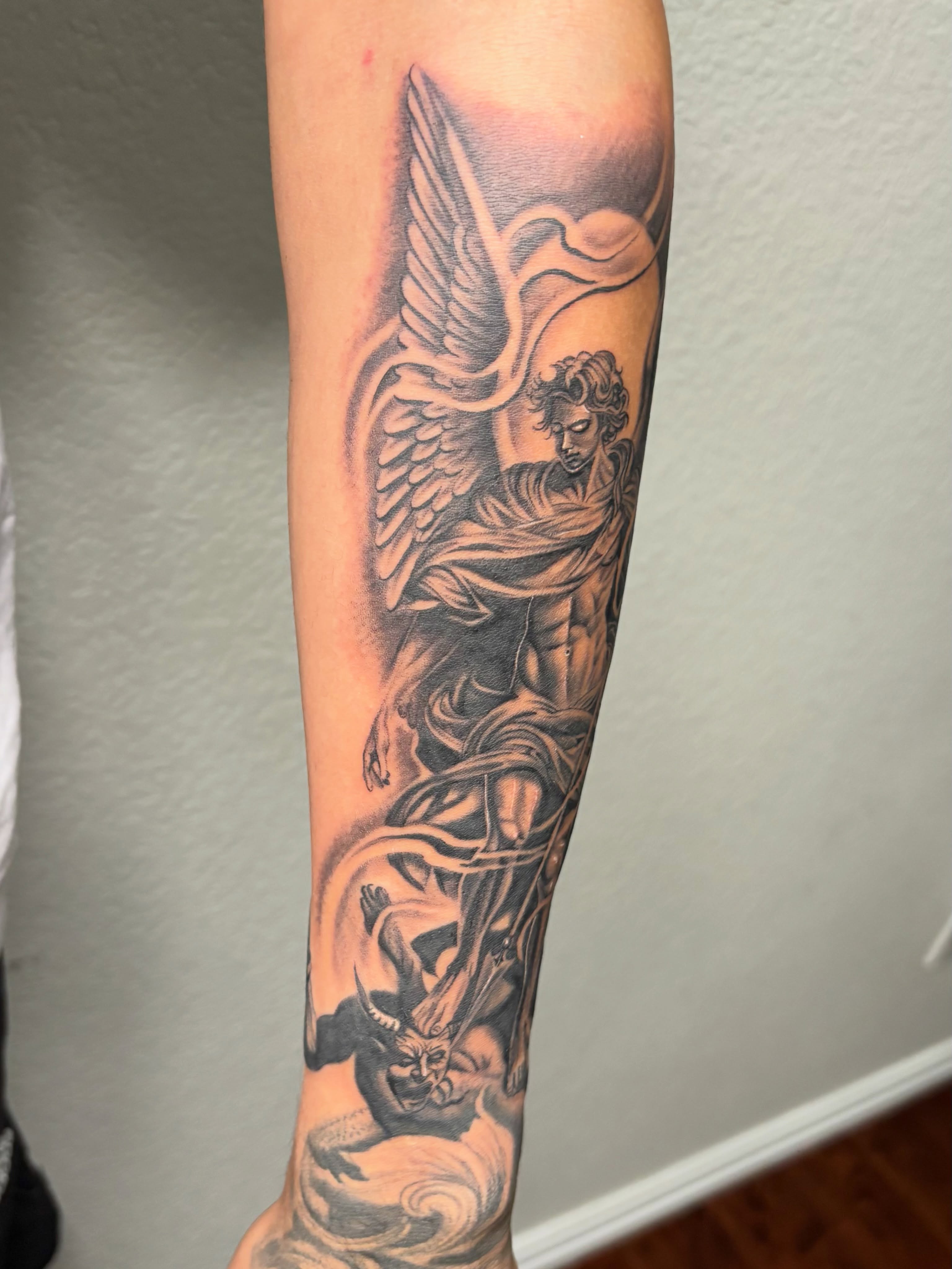 Angel and demon realism tattoo on the forearm by @tattoosbyadrian