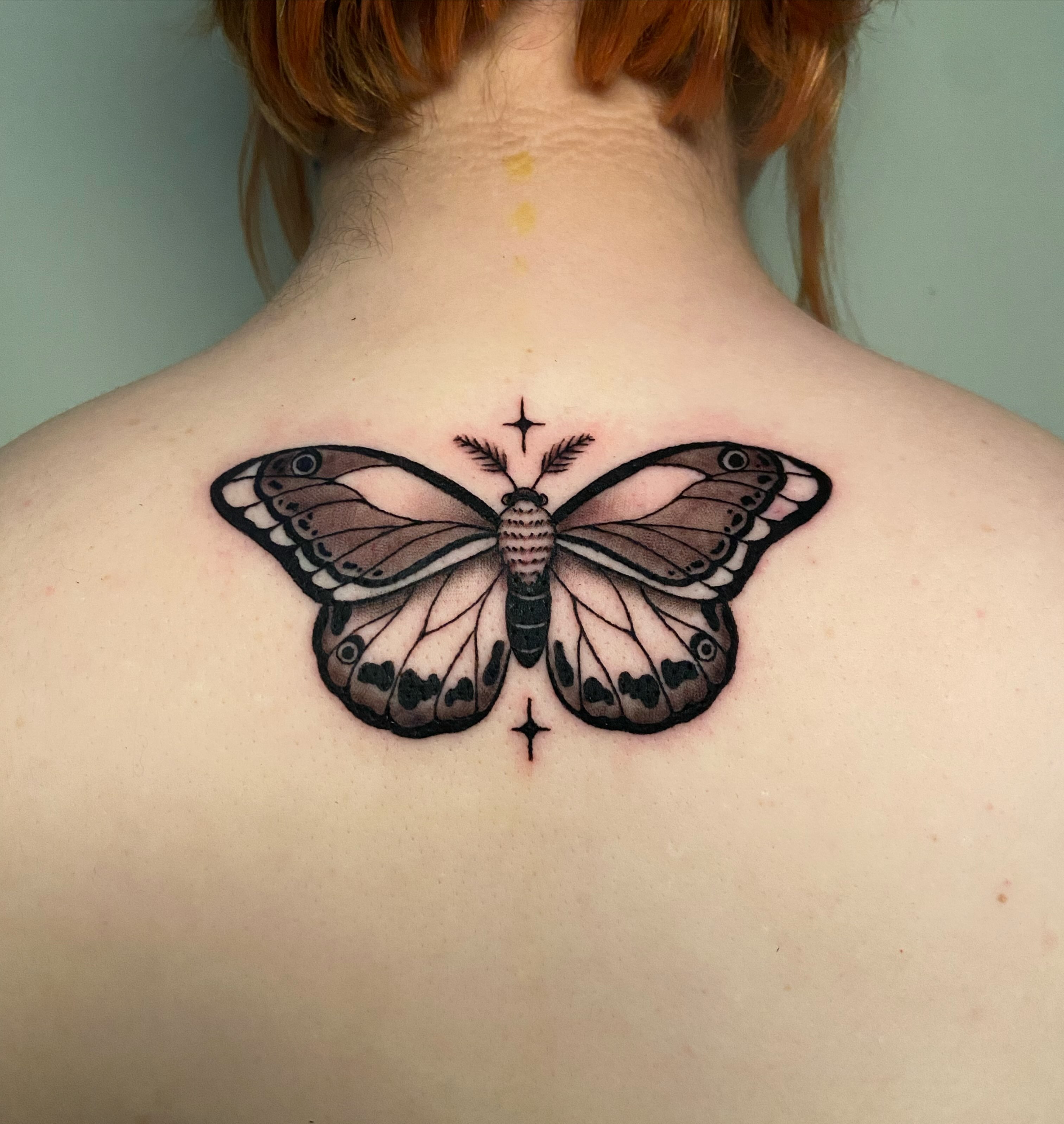 Butterfly realism tattoo on the back by Ezra Gonda