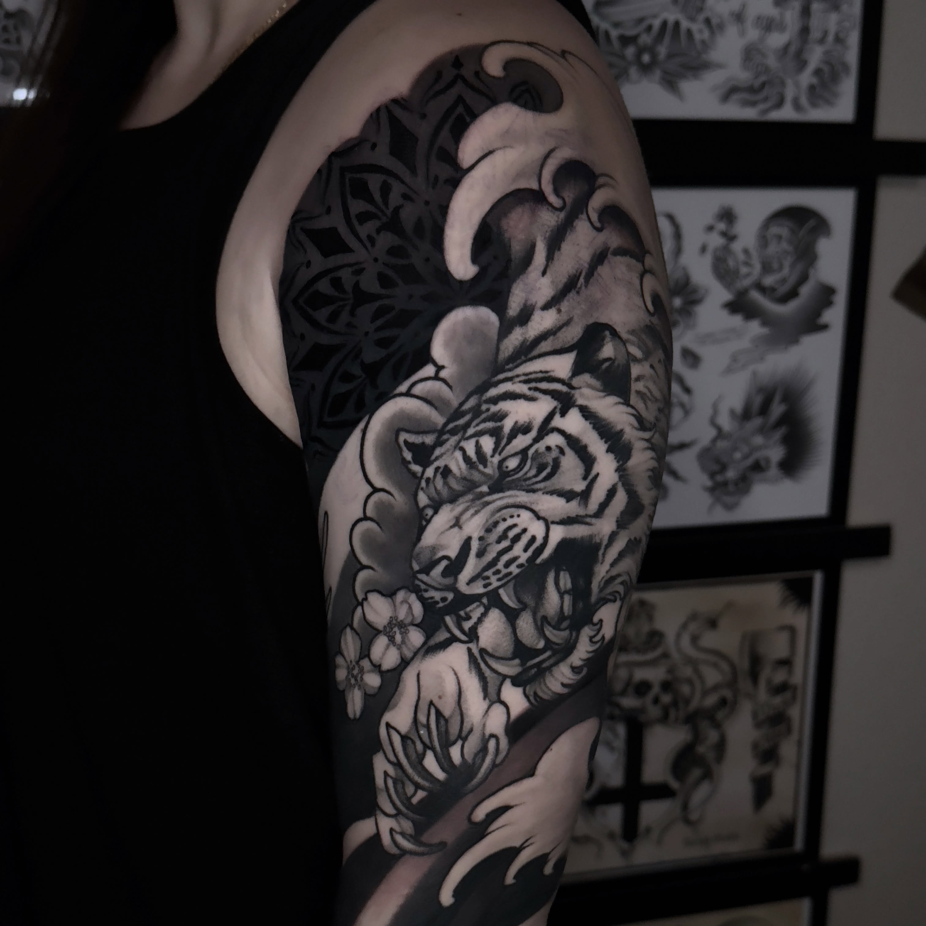 Tiger realism tattoo on the upper arm by Golden Heart Tattoo Co