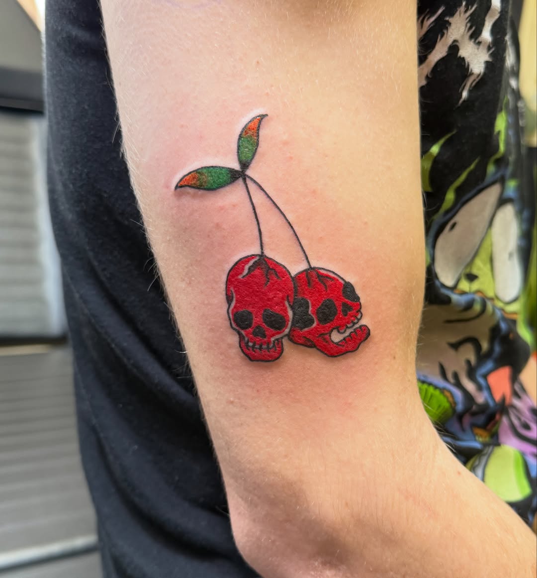 Cherry skulls American traditional tattoo on the forearm by Rachel Hanke