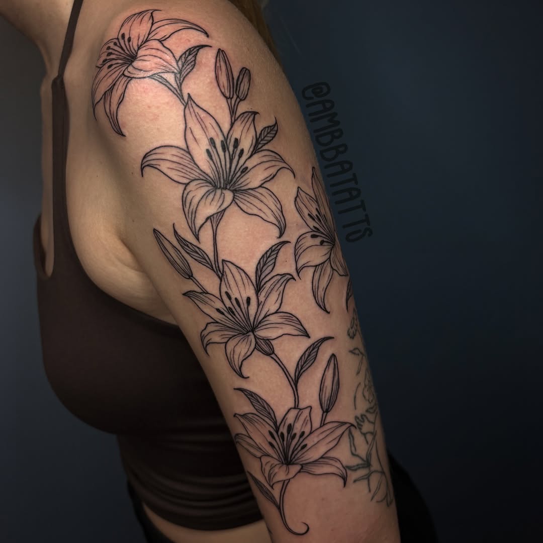 Lilies black and grey tattoo on the upper arm by amber brady, Brunswick, Ohio