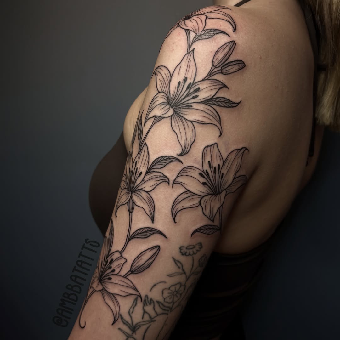 Lilies black and grey tattoo on the upper arm by amber brady, Brunswick, Ohio