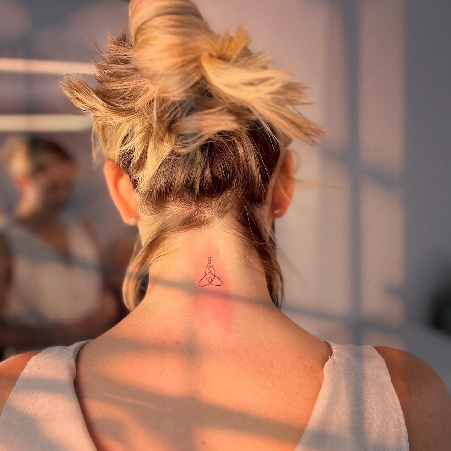Trinity knot geometric tattoo on the neck by Ellie
