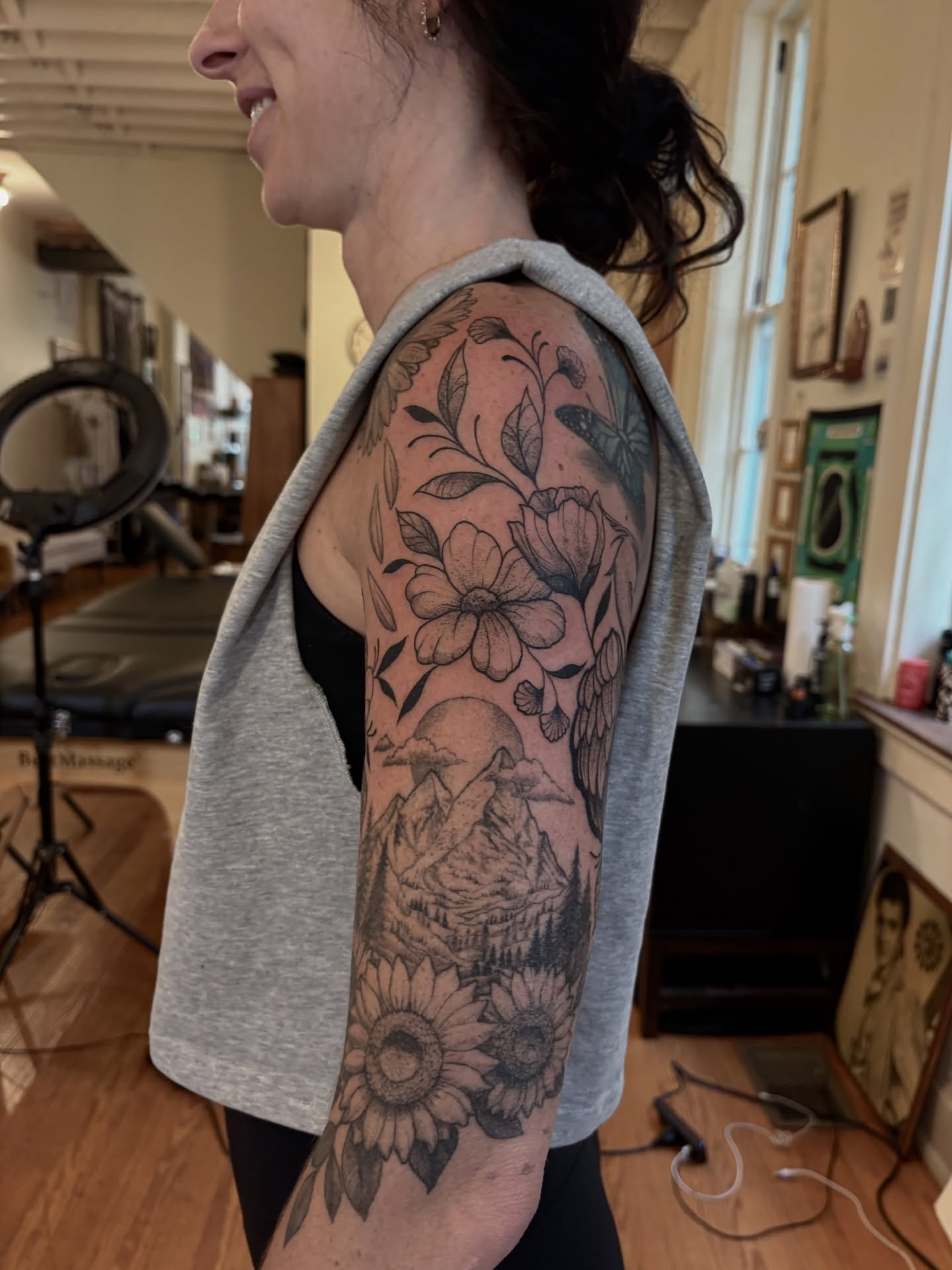 Mountain landscape with flowers realism tattoo on the upper arm by V ☆ Cincinnati Tattoo Artist