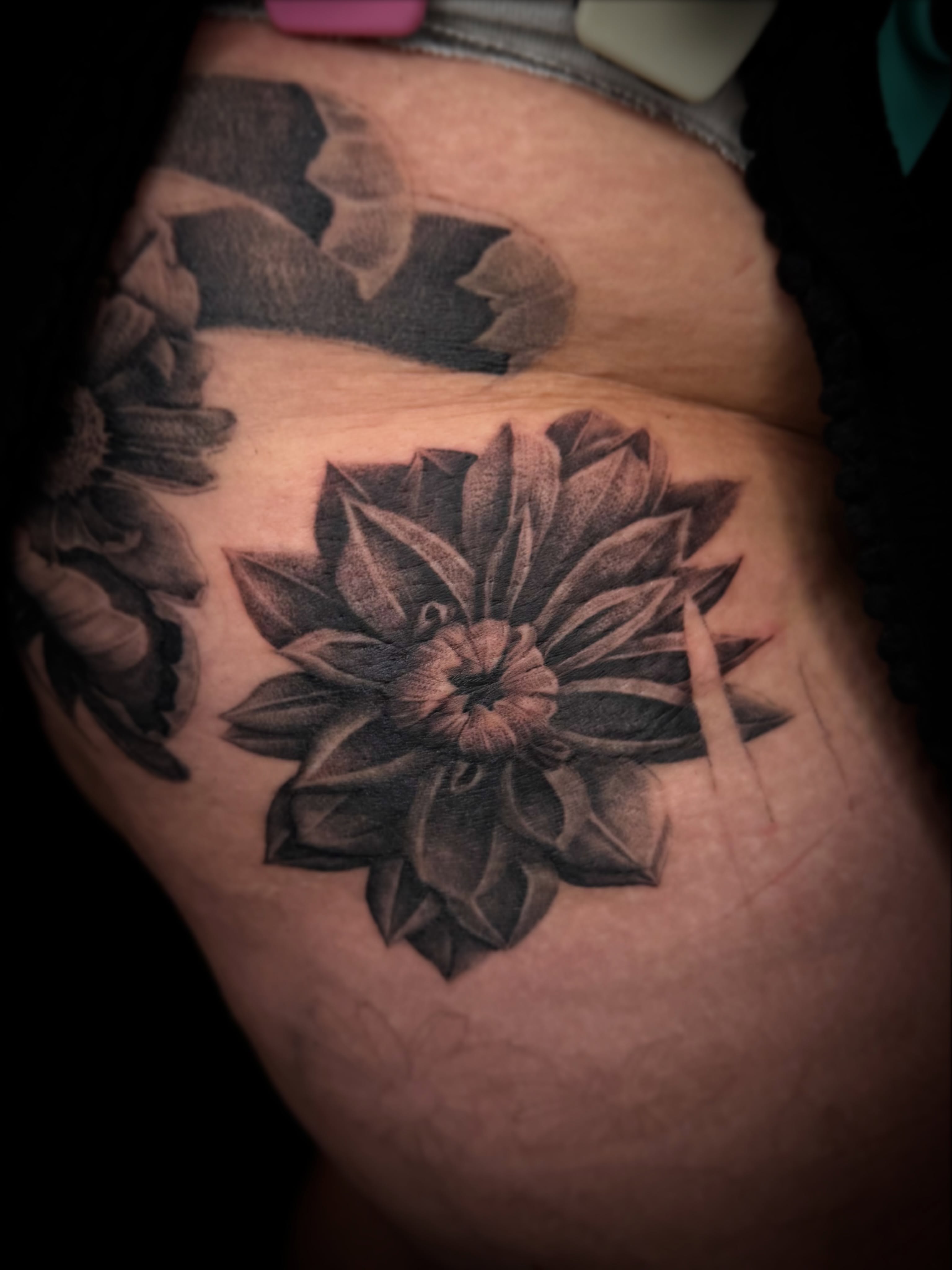 Dahlia black and grey tattoo on the thigh by Aaron Strobehn