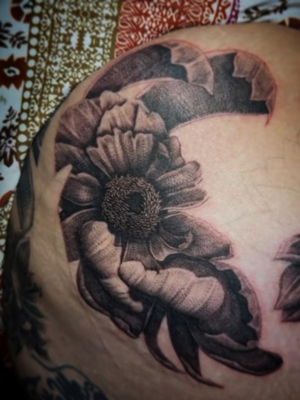 Sunflower dotwork tattoo on the shoulder by Aaron Strobehn
