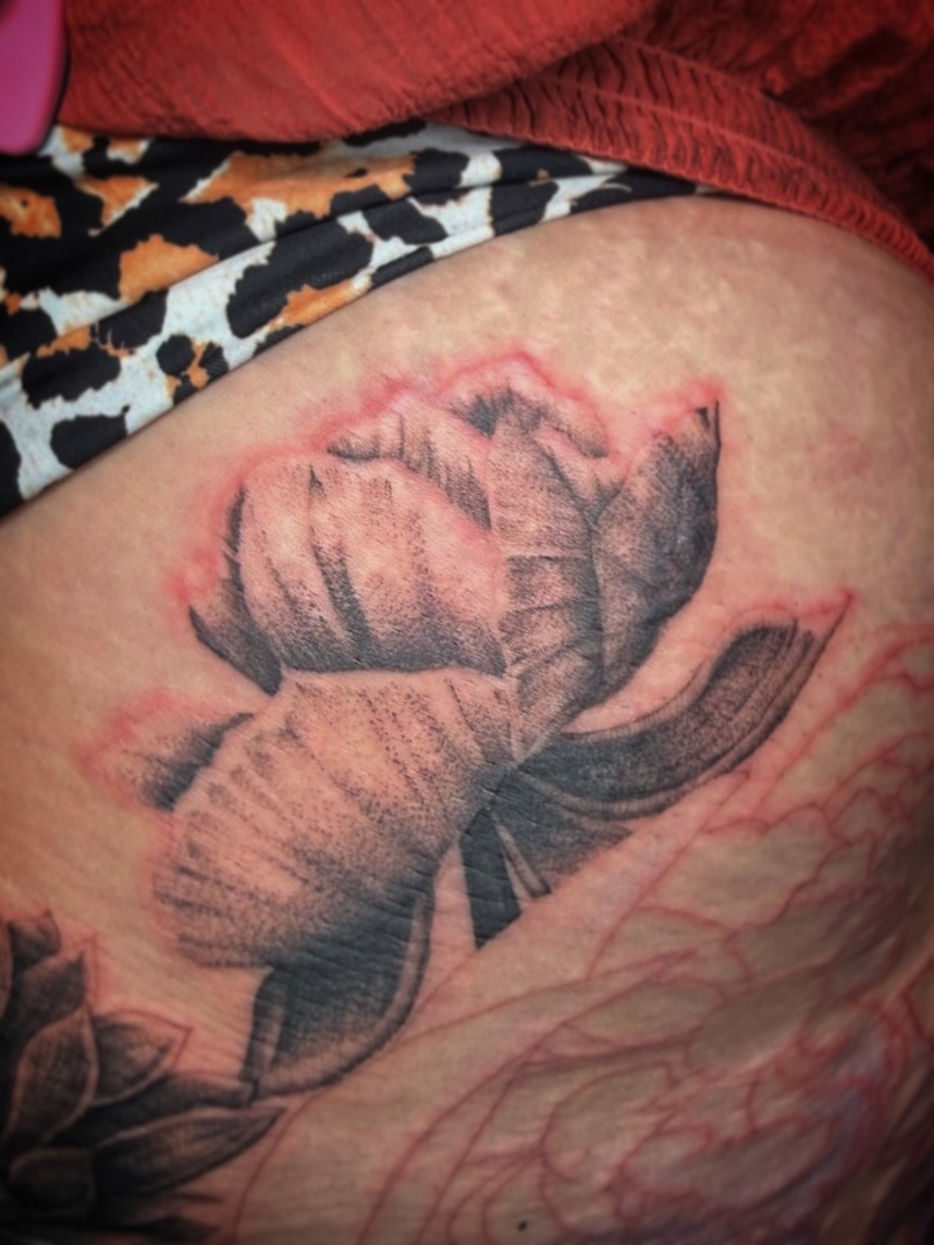 Lotus flower dotwork tattoo on the thigh by Aaron Strobehn
