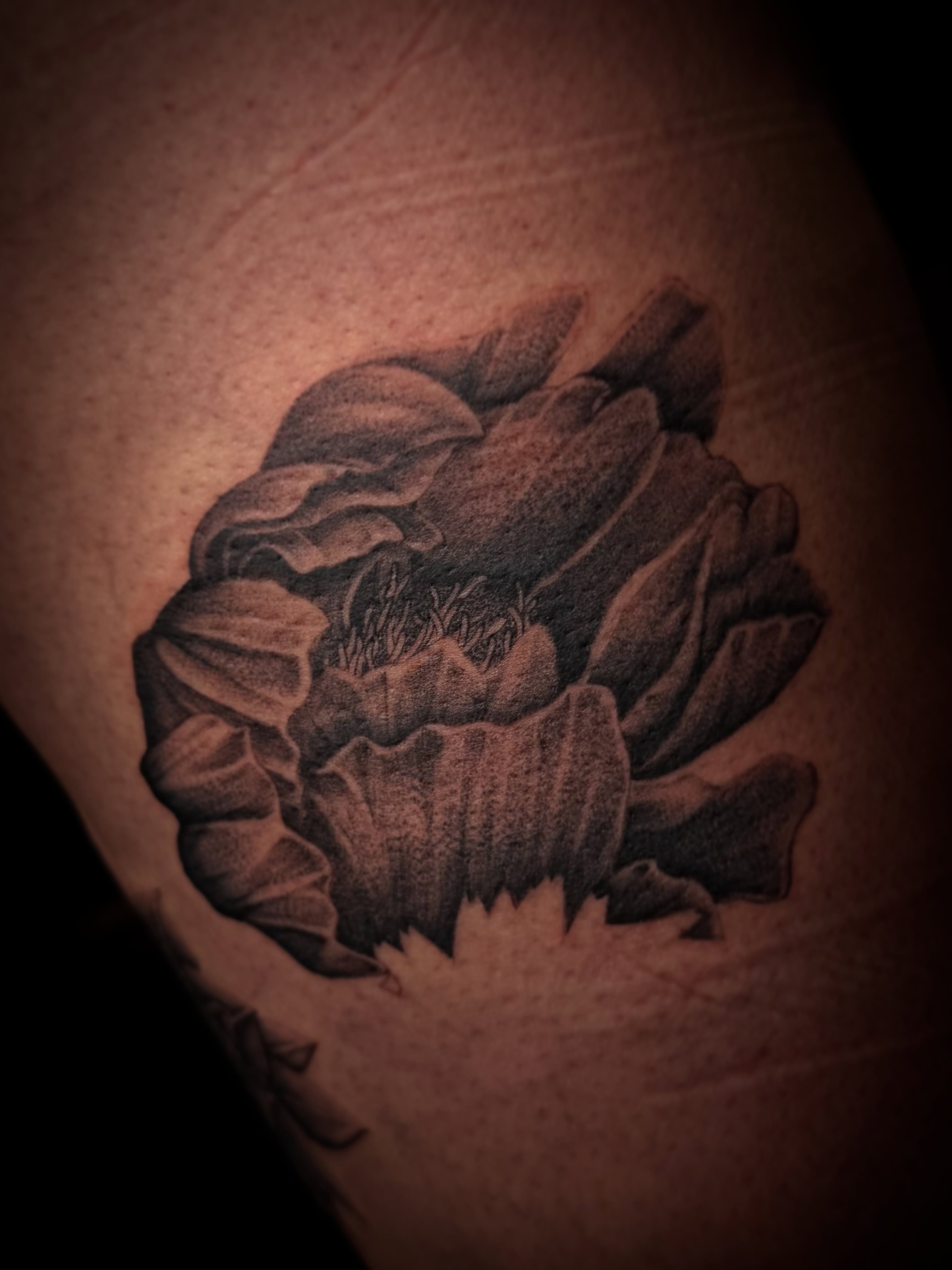 Flower black and grey tattoo on the shoulder by Aaron Strobehn