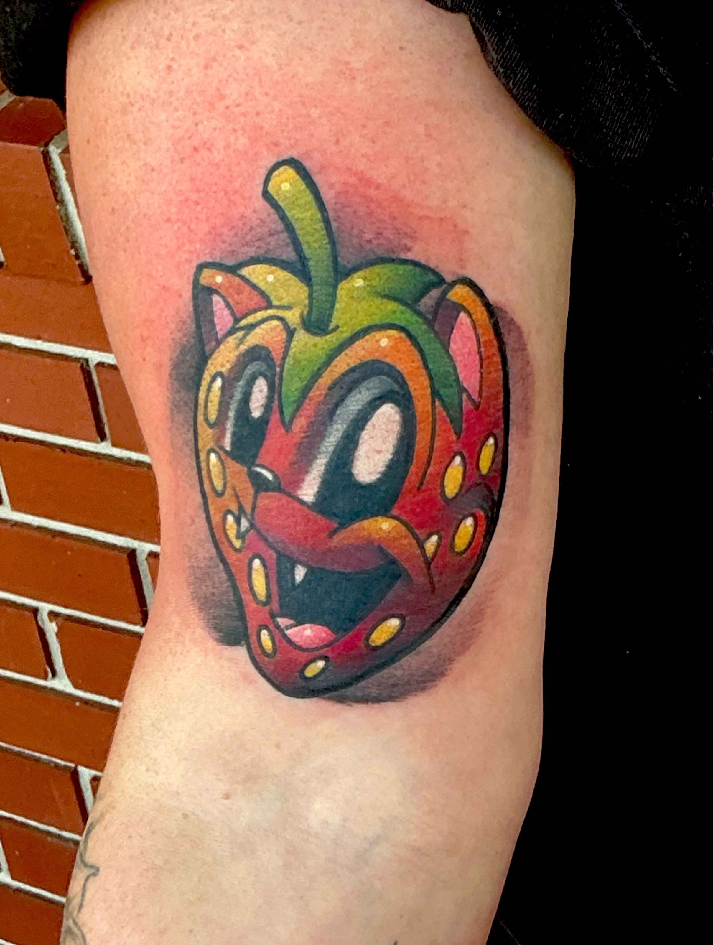 Strawberry trash polka tattoo on the forearm by Jeremy Harburn, Young Harris, Georgia