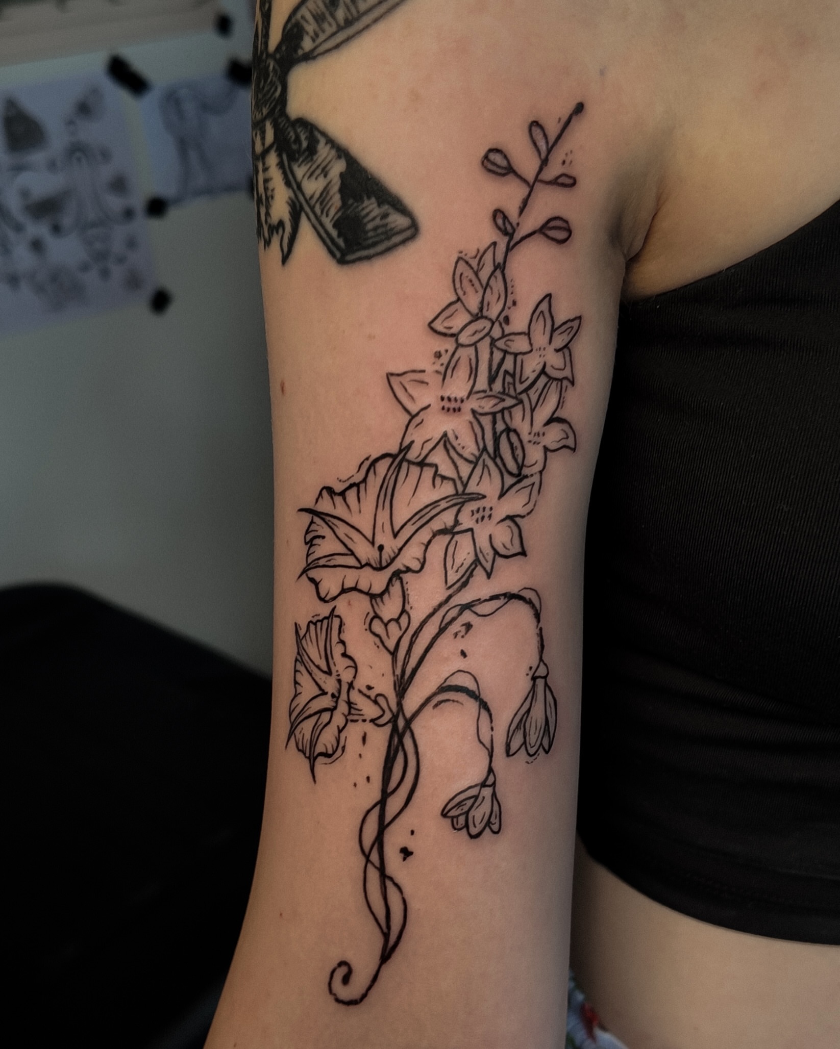 Flowers black and grey tattoo on the forearm by Morgan Diann
