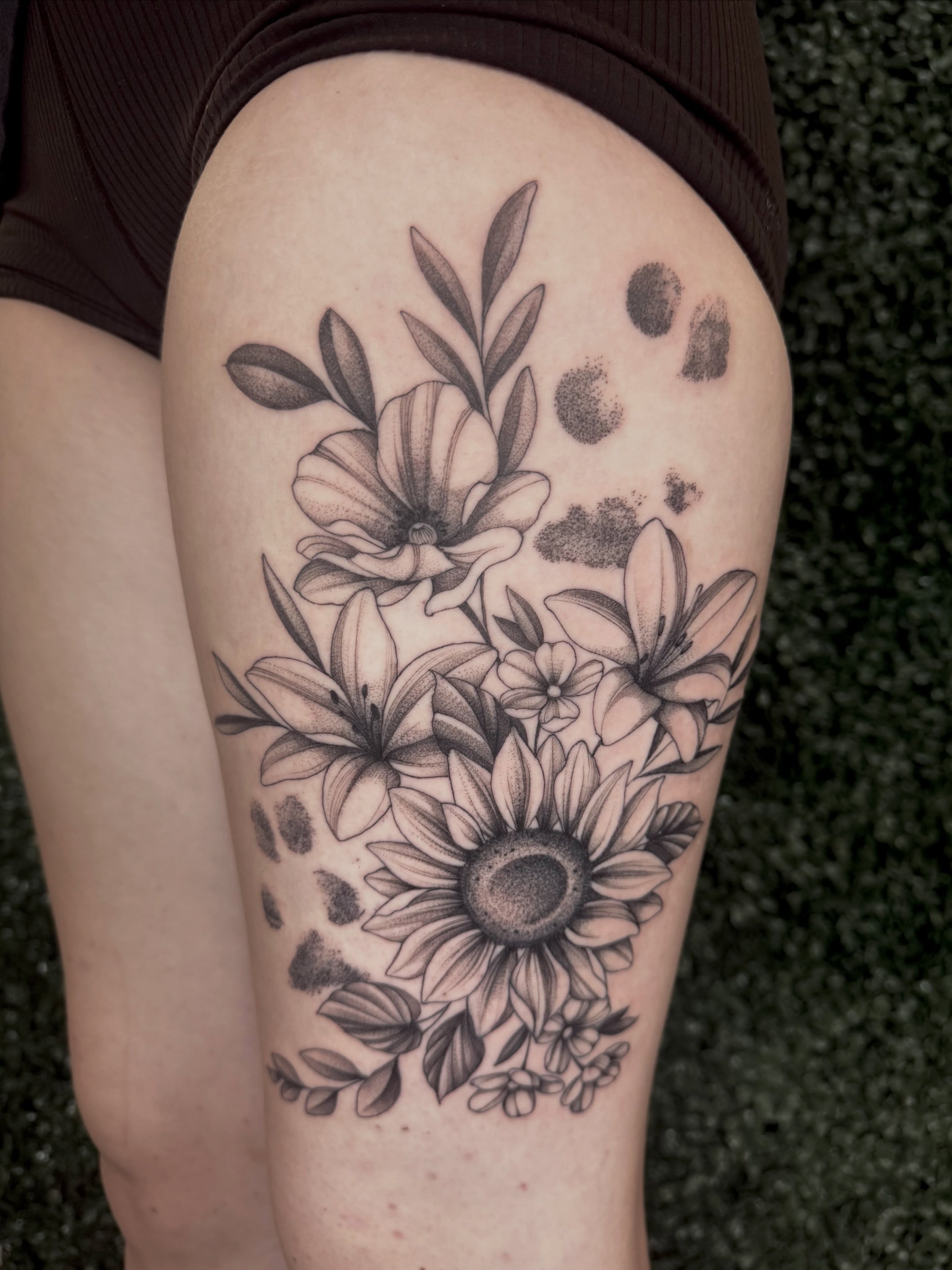 Sunflower bouquet dotwork tattoo on the thigh by Chelsea Speirs