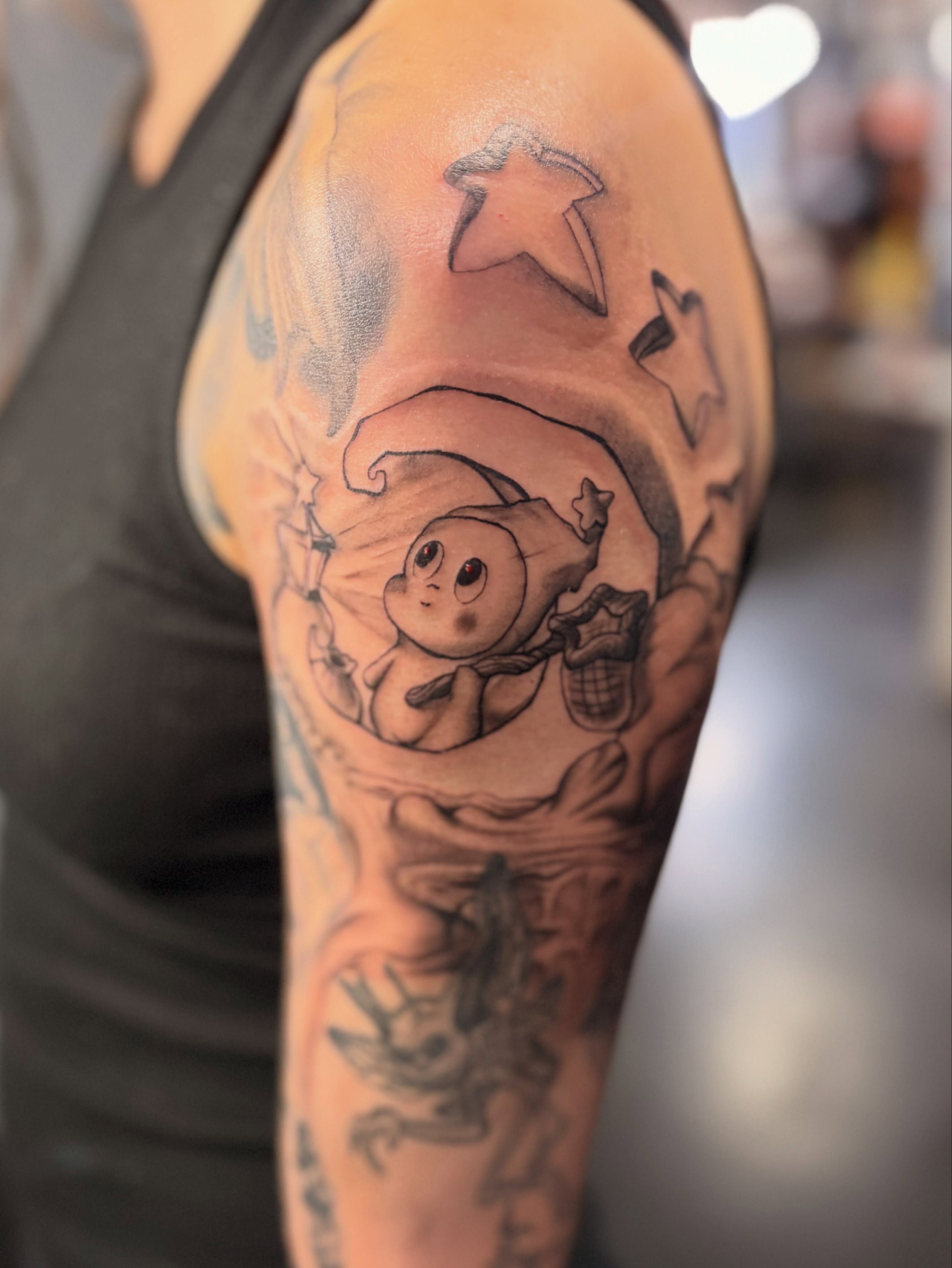 Elf character black and grey tattoo on the upper arm by Slade Nowicki