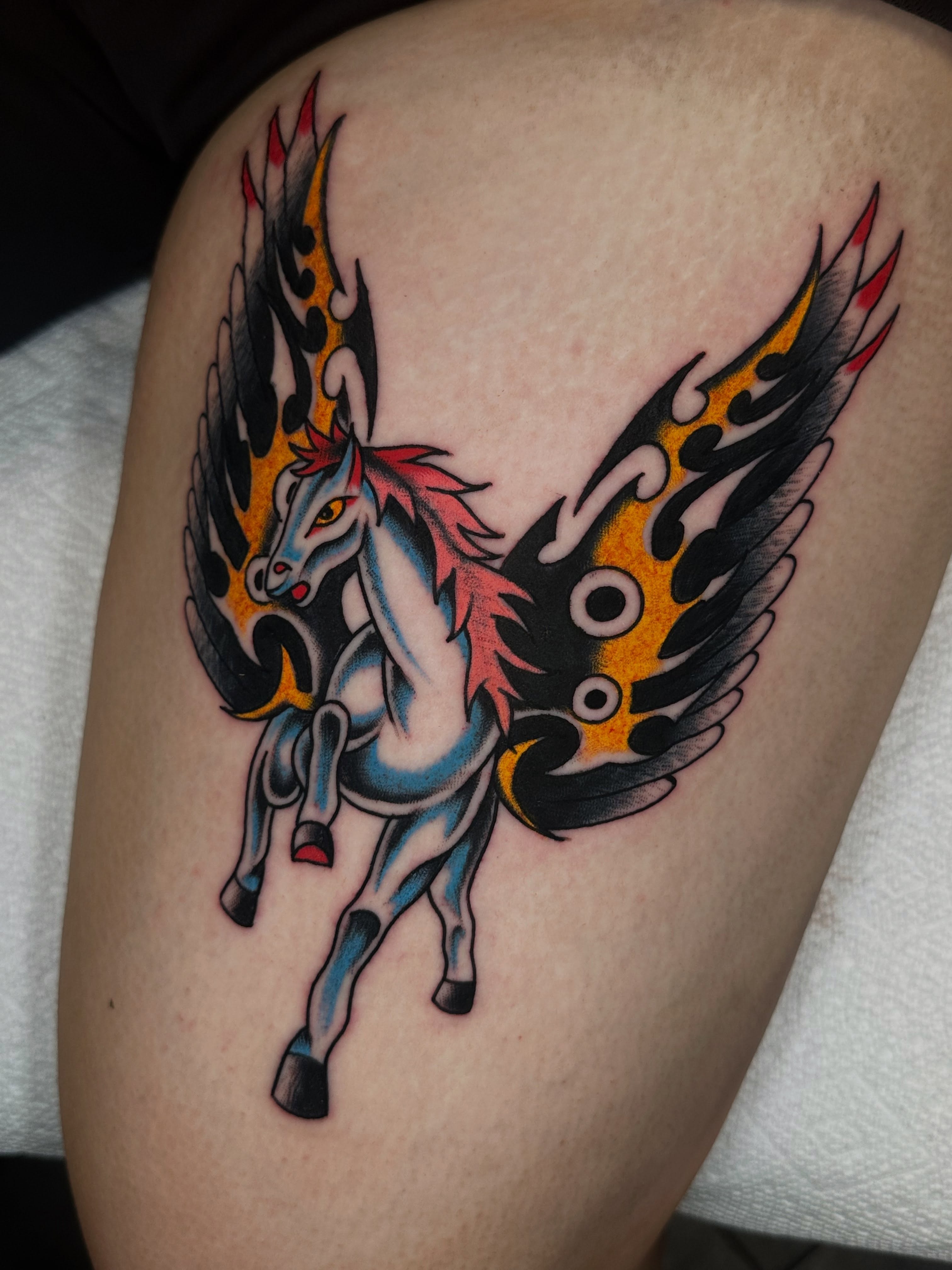 Winged unicorn American traditional tattoo on the thigh by Spencer Crawford, Speedway, Indiana