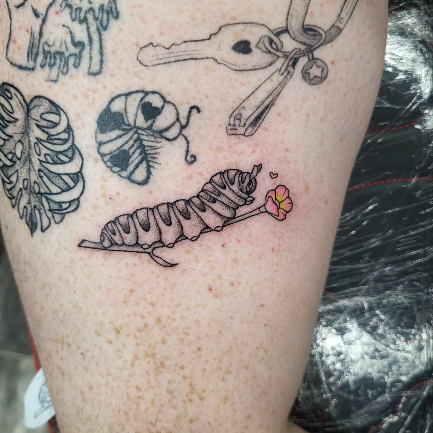 Caterpillar black and grey tattoo on the forearm by TEA ☕️ Tattoos