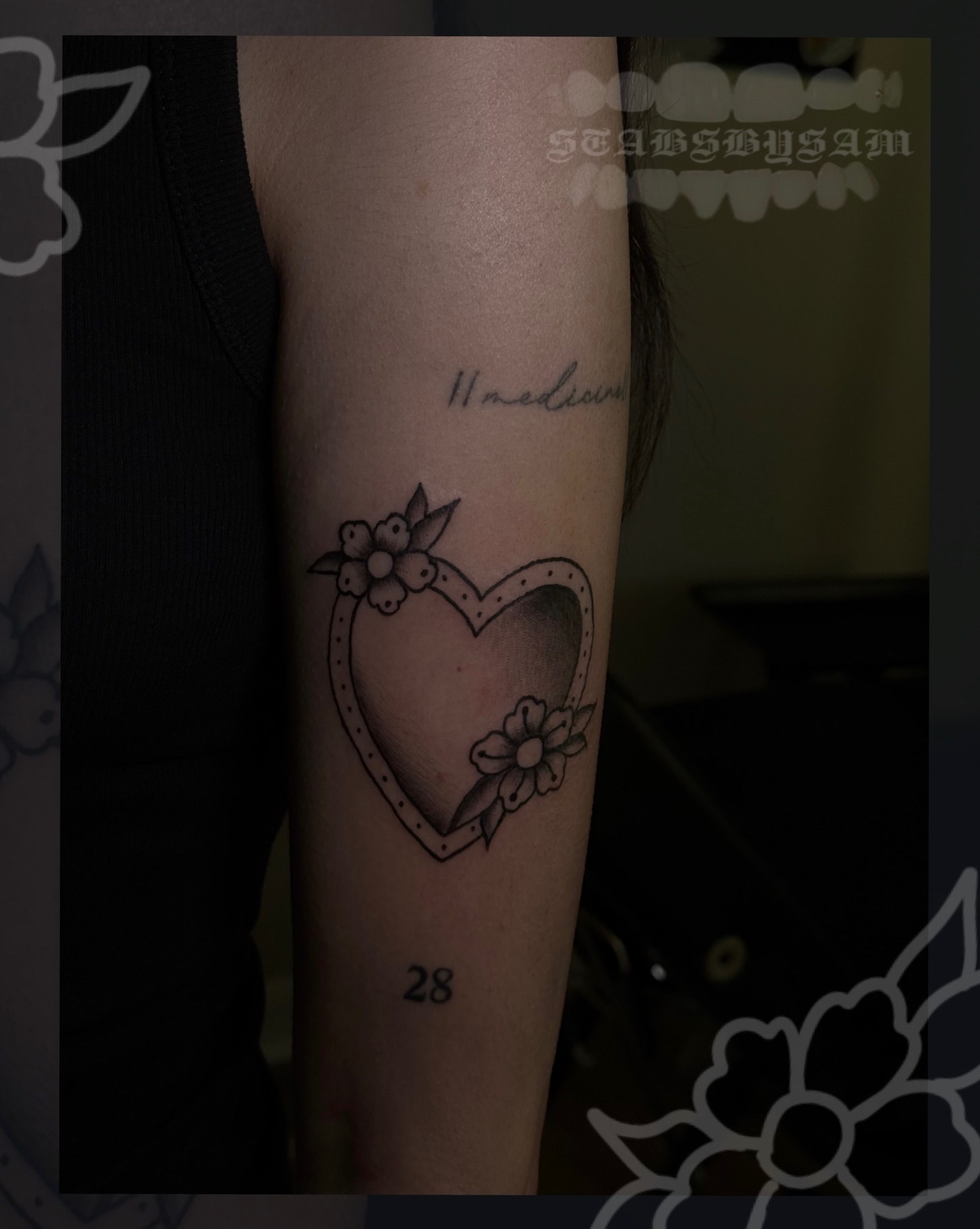 Heart with flowers black and grey tattoo on the forearm by licensed charlotte tattoo artist