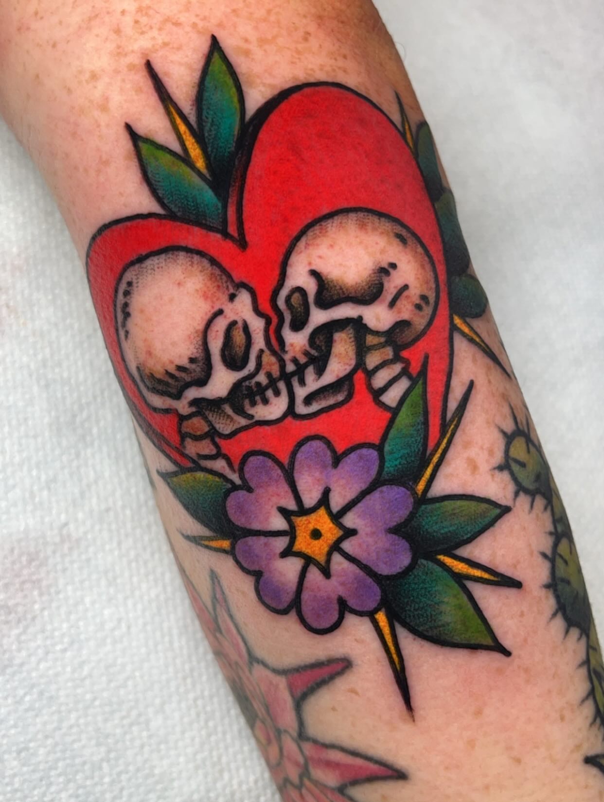 Skulls and heart American traditional tattoo on the forearm by Mat Helton, Fairborn, Ohio