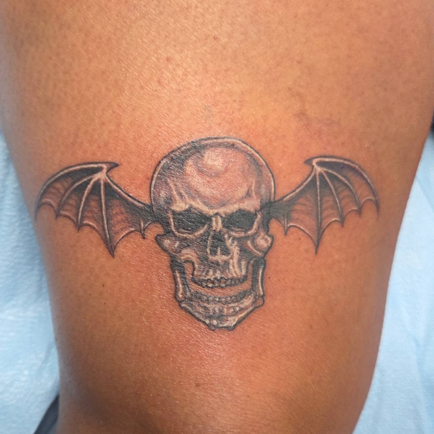 Bat skull black and grey tattoo on the thigh by Matthew Todd Kremer