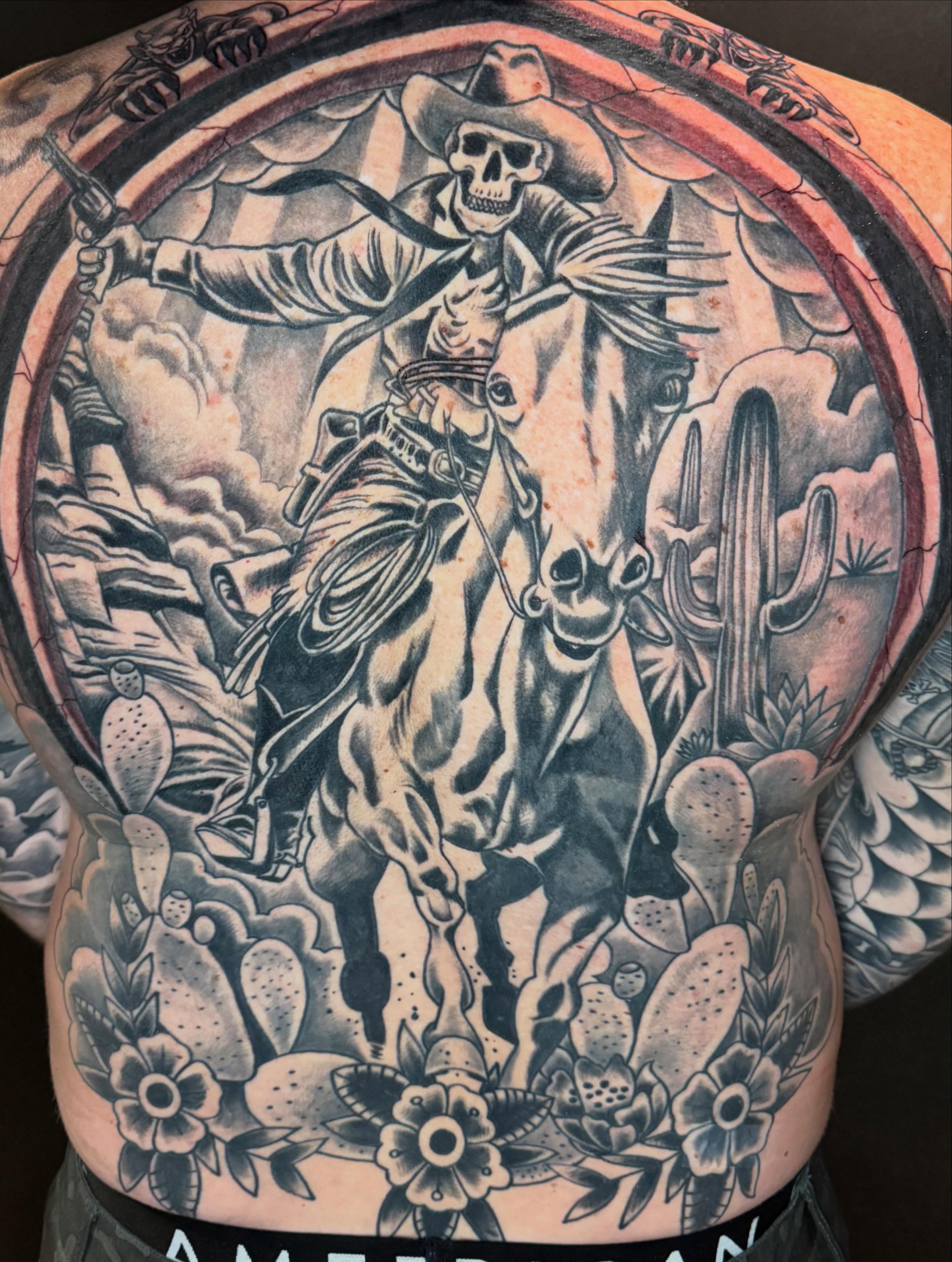 Cowboy skeleton riding horse American traditional tattoo on the back by George Zabala, Rockdale, Illinois