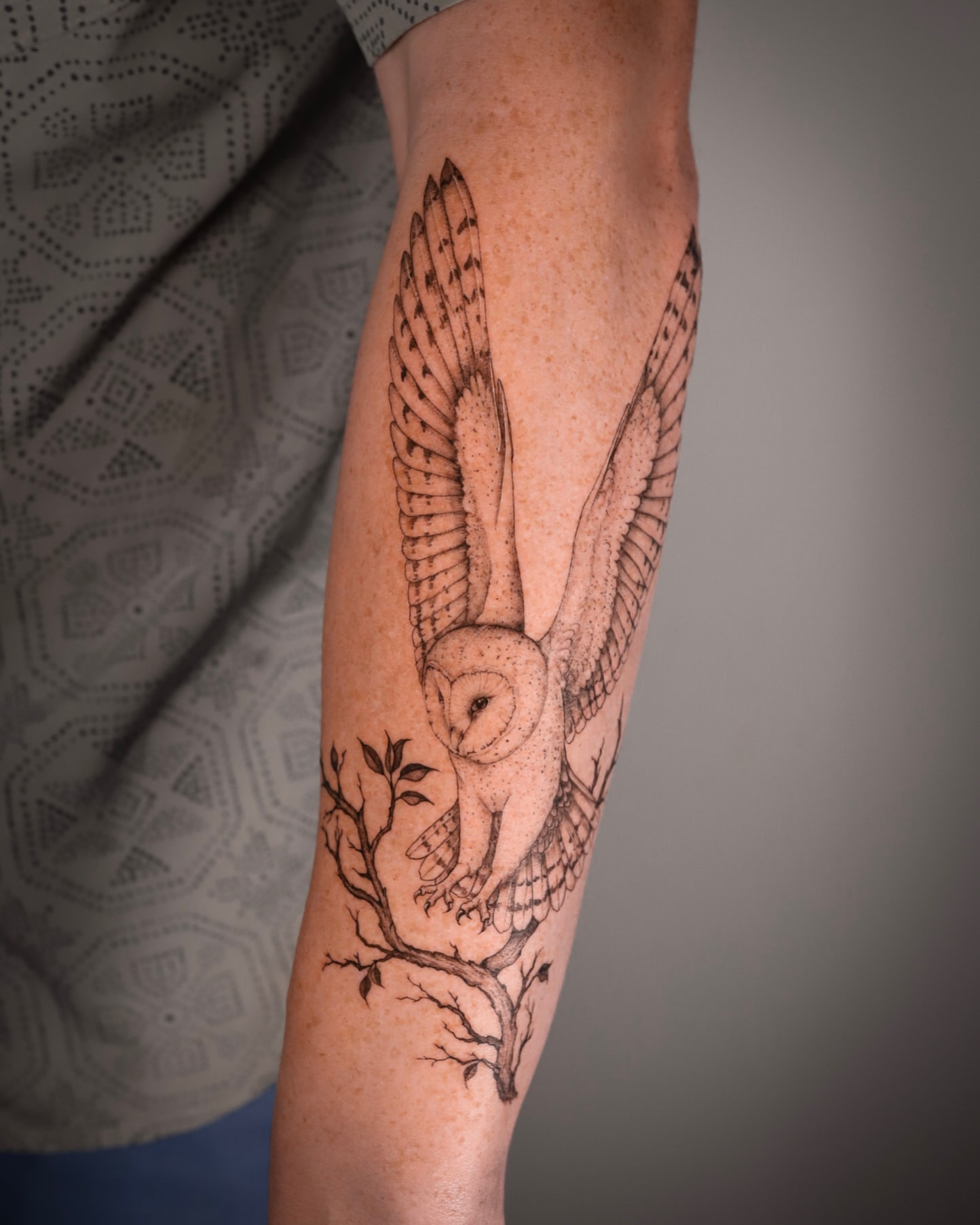 Owl black and grey tattoo on the forearm by Caroline + Utah Tattoo Artist