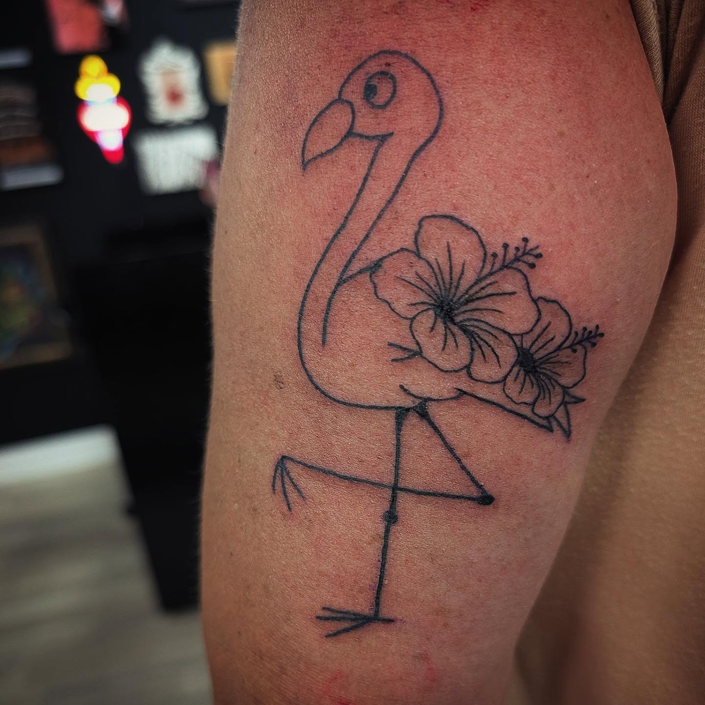 Flamingo and flowers minimalist tattoo on the forearm by Matt Mahl