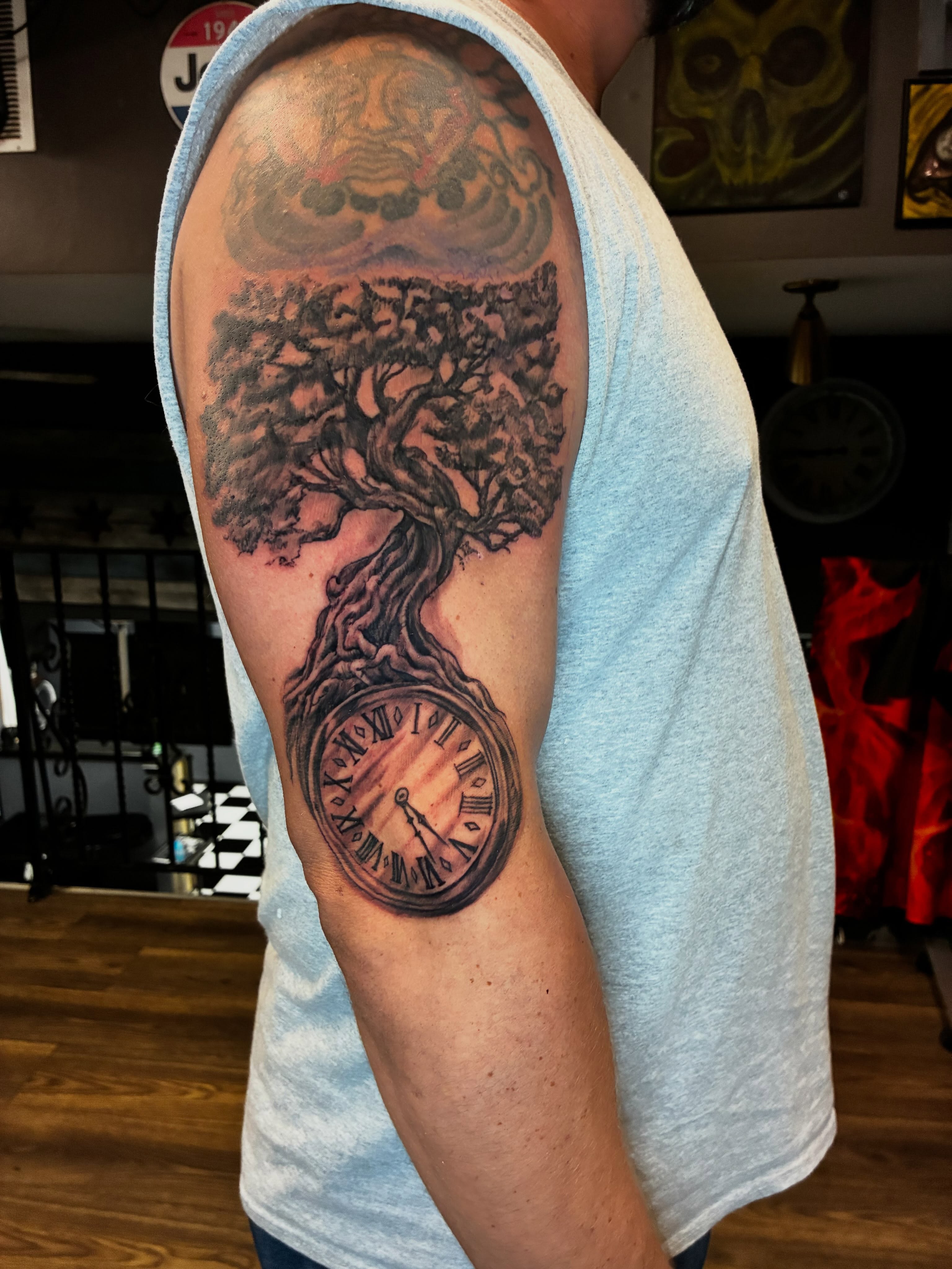 Tree and clock realism tattoo on the forearm by Kevin Strong