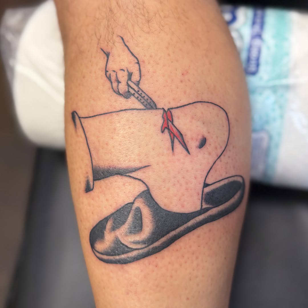 Cowboy boot and spurs black and grey tattoo on the forearm by Zac Tattooer