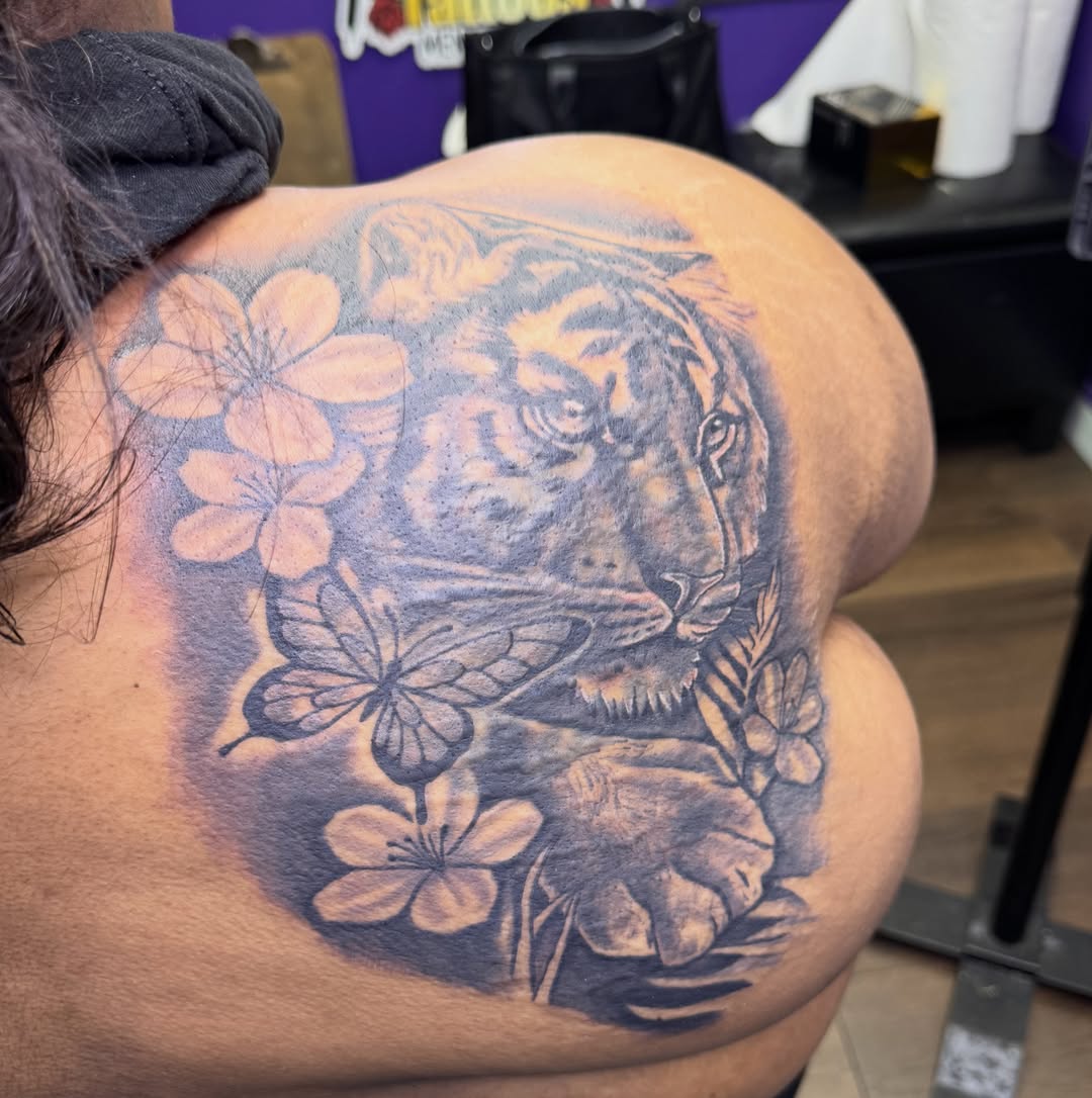 Tiger and flowers realism tattoo on the back by Christian Goines, Memphis, Tennessee