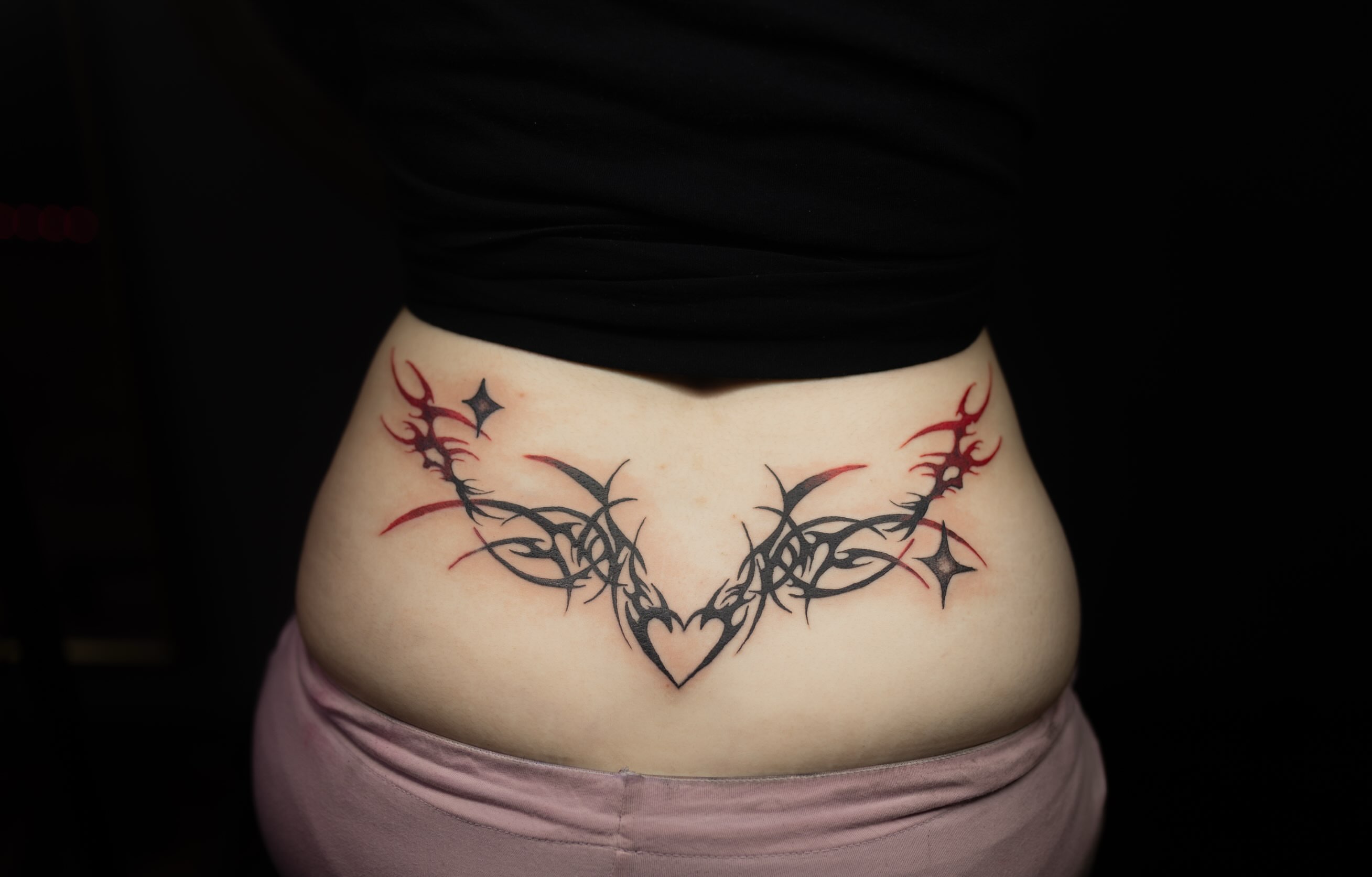 Tribal heart tribal tattoo on the torso by Kelsie