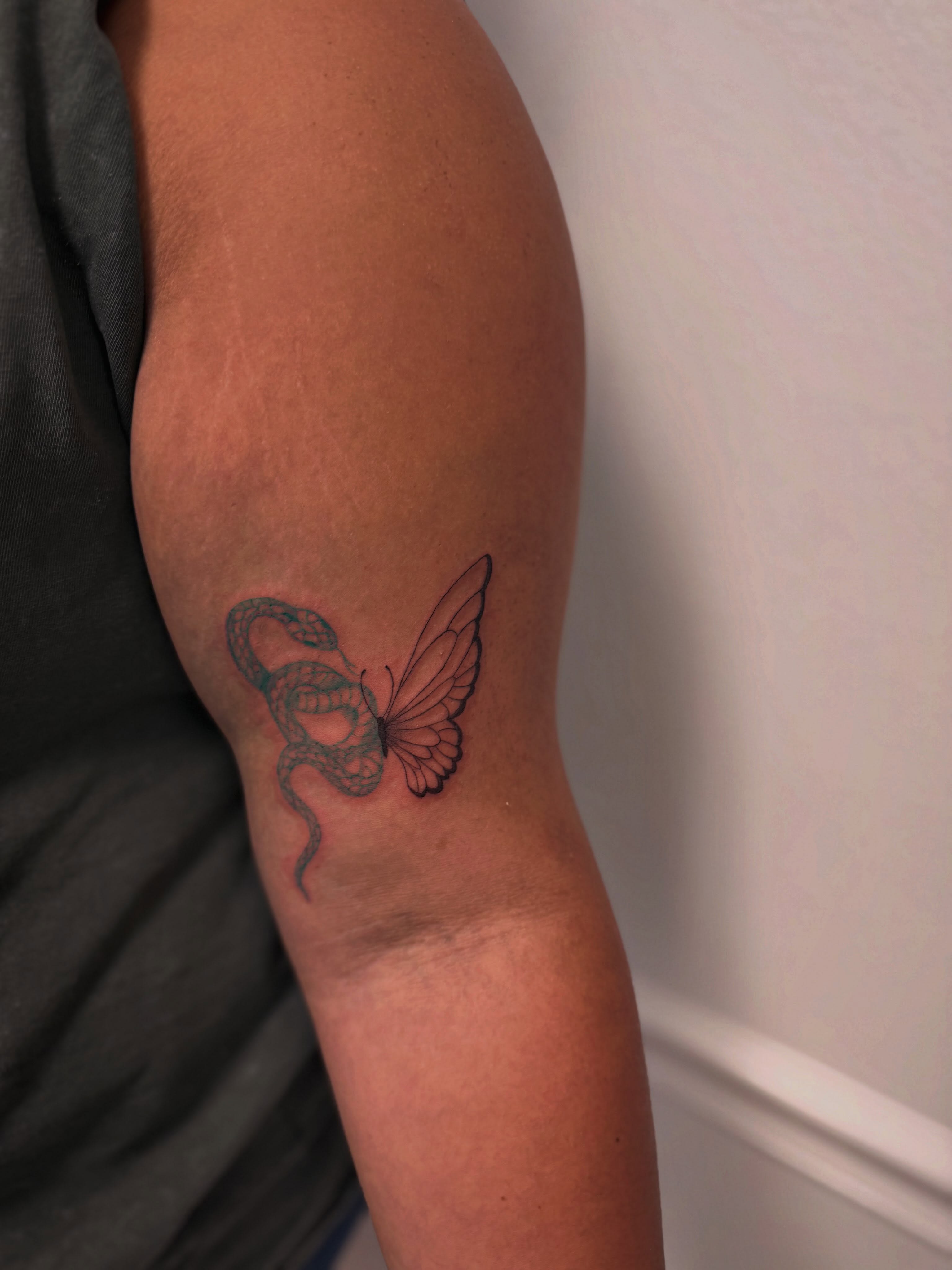 Snake and butterfly black and grey tattoo on the forearm by Taylor Johnson